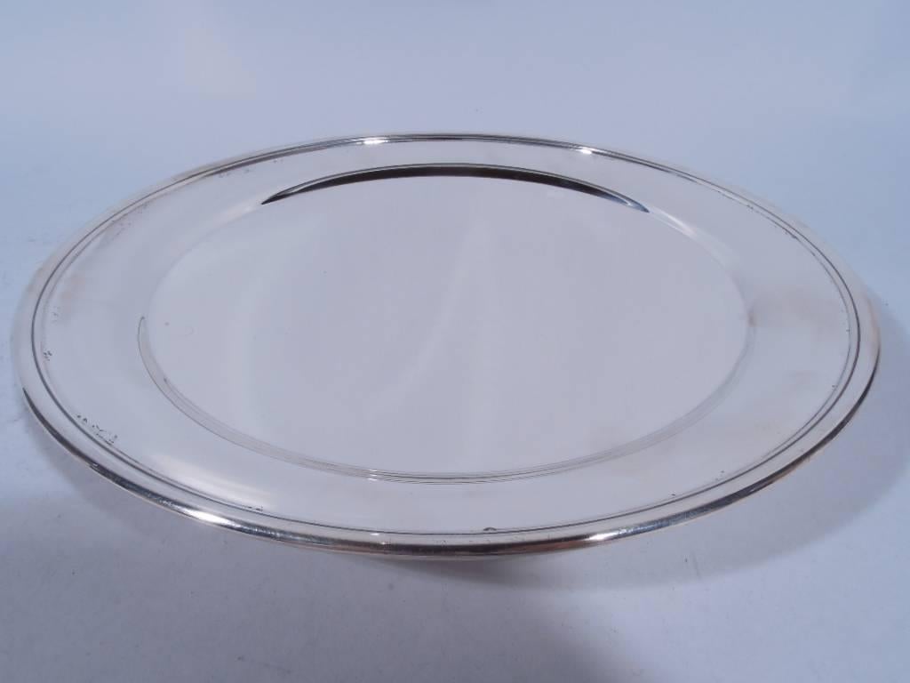 Edwardian sterling silver footed plate. Made by Tiffany & Co. in New York, circa 1914. Circular well, applied rim and short foot. From appetizers to dessert - a great addition to the table. Hallmark includes pattern no. 18678 (first produced in