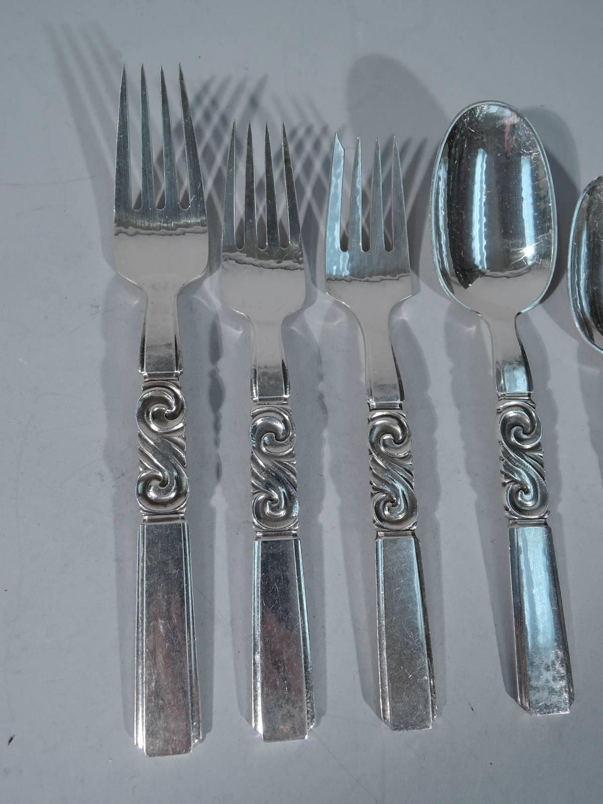 Sterling silver dinner service for 12 in scroll pattern. Made by Georg Jensen in Copenhagen. This service comprises 93 pieces (all dimensions in inches): Forks: 12 dinner forks (7), 12 dessert forks (6 3/8), 12 salad forks (6 1/4), Spoons: 12 oval