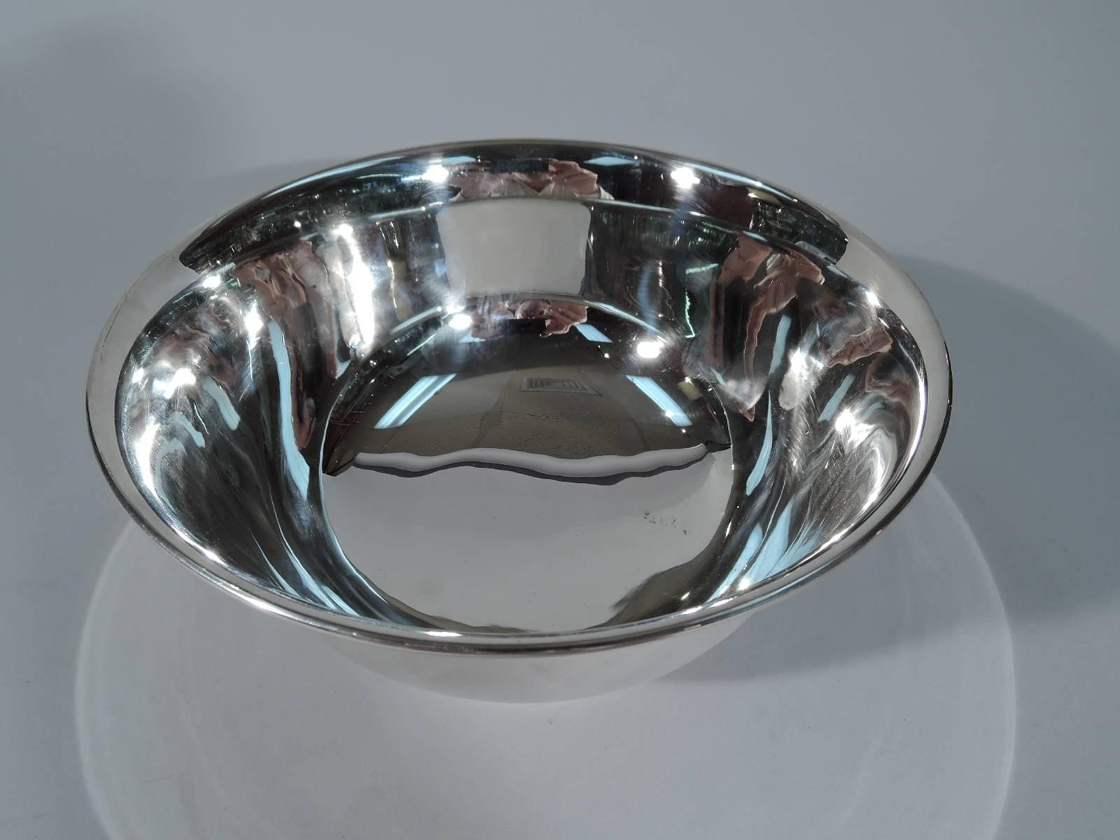 Sterling silver footed bowl. Made by Tiffany & Co. in New York, circa 1917. Curved with flared and molded rim and stepped foot. Traditional Revere form. Nice size. Hallmark includes pattern no. 19424A (first produced in 1917) and director’s letter m