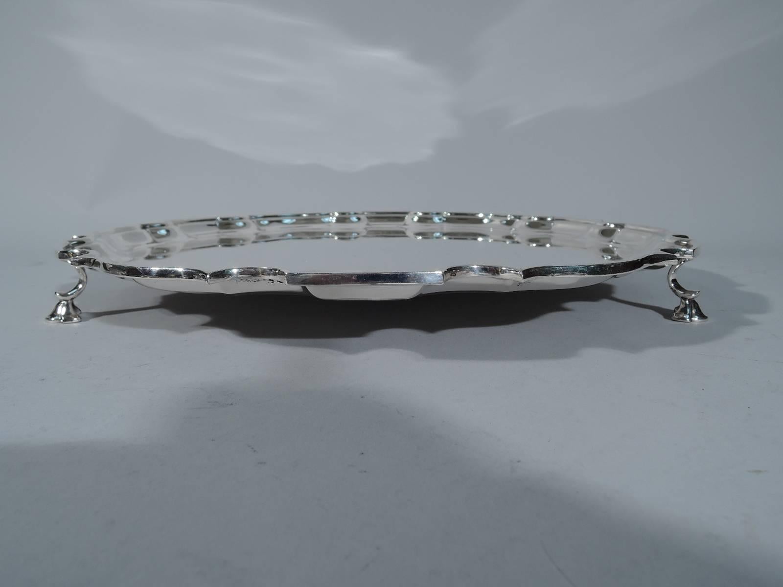 Georgian sterling silver salver tray. Made by Tiffany & Co. in New York. Circular with molded curvilinear piecrust rim. Three supports on c-scroll mounts. A great piece in the traditional style. Hallmark includes postwar pattern no. 24073.Very good