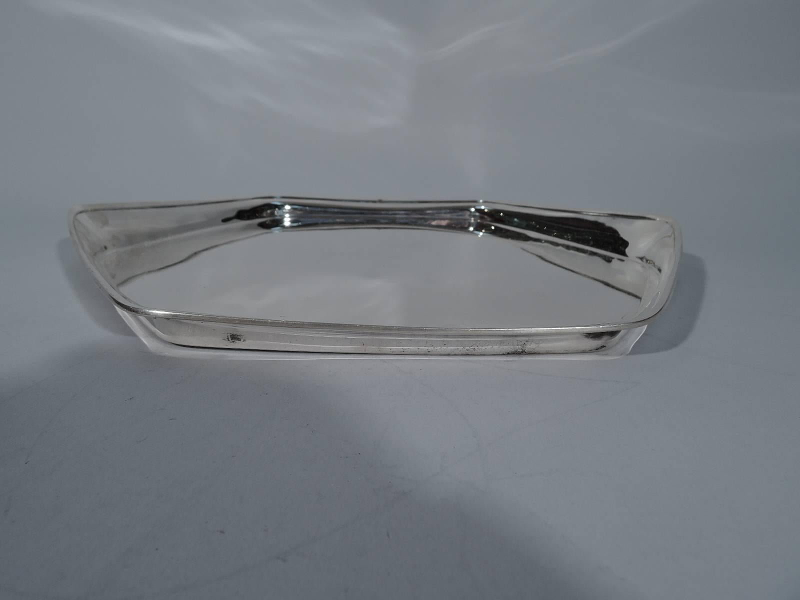 Sterling silver tray. Made by Tiffany & Co. in New York, circa 1911. Hexagonal with unusual asymmetrical rim. An exciting experimental design. Hallmark includes pattern no. 17928 (first produced in 1911) and director’s letter m (1907-1947). Very