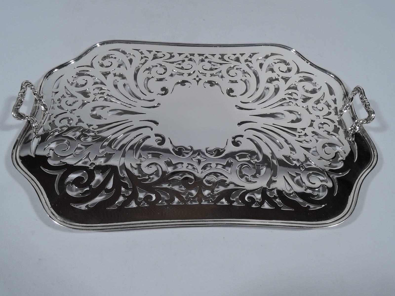 Sterling silver asparagus tray in Marquise pattern. Made by Tiffany & Co. in New York, circa 1902. Four tapering and wavy sides with chamfered corners. Bead-and-reel rim. Rests on four corner supports, each terminating in volute scroll. Hallmark