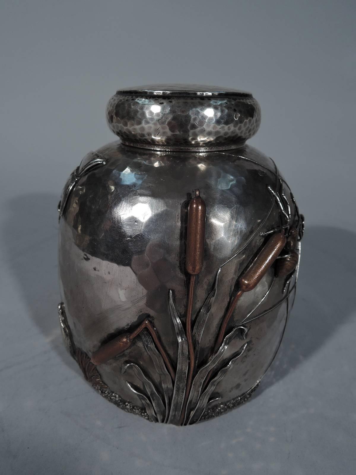 Fabulous Japonesque sterling silver and mixed metal tea caddy. Made by Gorham in Providence in 1884. Dome body with short neck. Flat cover with curved sides. Mixed metal bird (crane), insects (spider and butterfly), and plants (cattails and