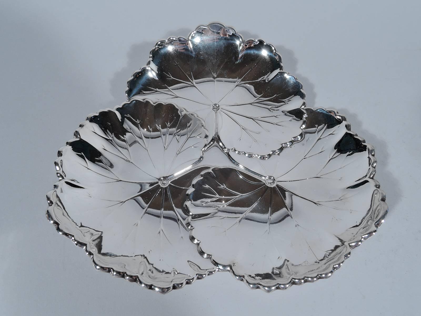 Sterling silver bowl. Made by Reed & Barton in Taunton, Mass. in 1948. Three overlapping lily pads with veins and scalloped edges. A stylish dish that harks back to the Japonesque vogue early in the century. Hallmark includes pattern no. X101 and