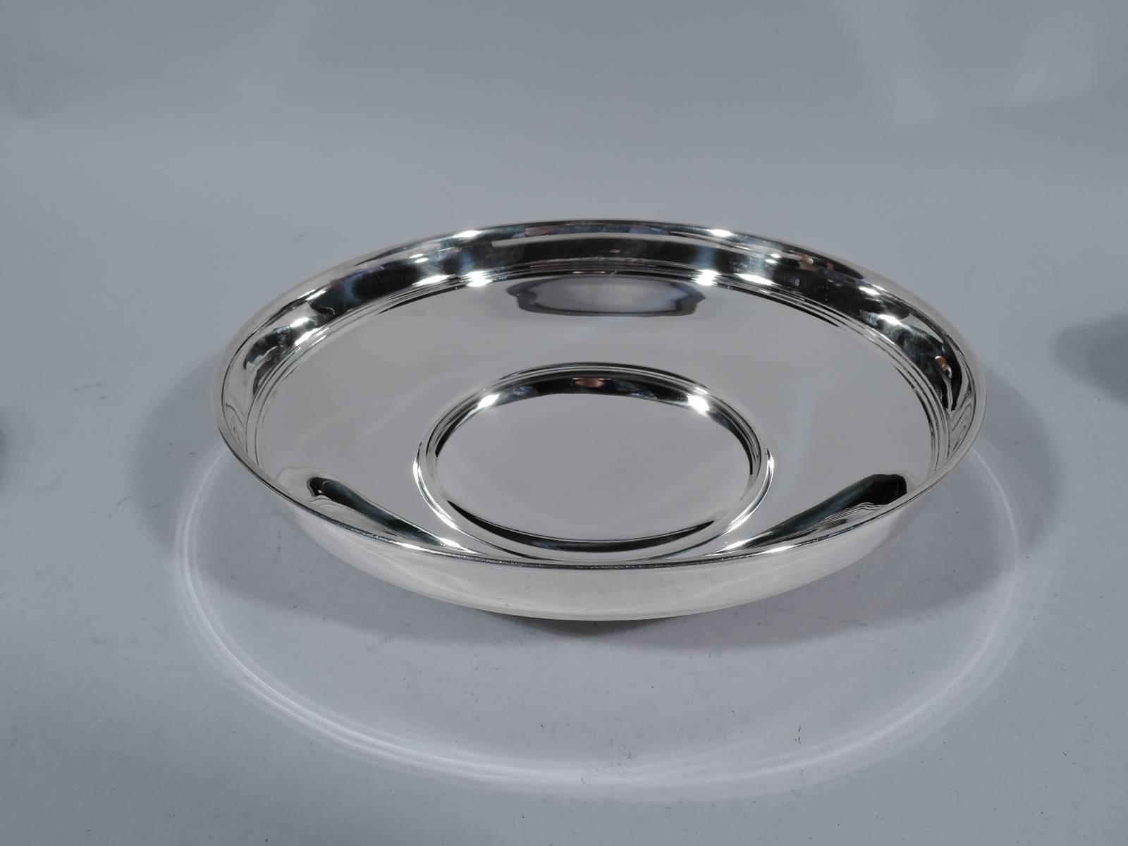 Sterling silver bowl. Made by Tiffany & Co. in New York, circa 1914. Round and shallow bowl with concave underside and straight sides with reeded band. Hallmark includes pattern no. 18720 and director’s letter ‘M’ (1907-1947). Very good