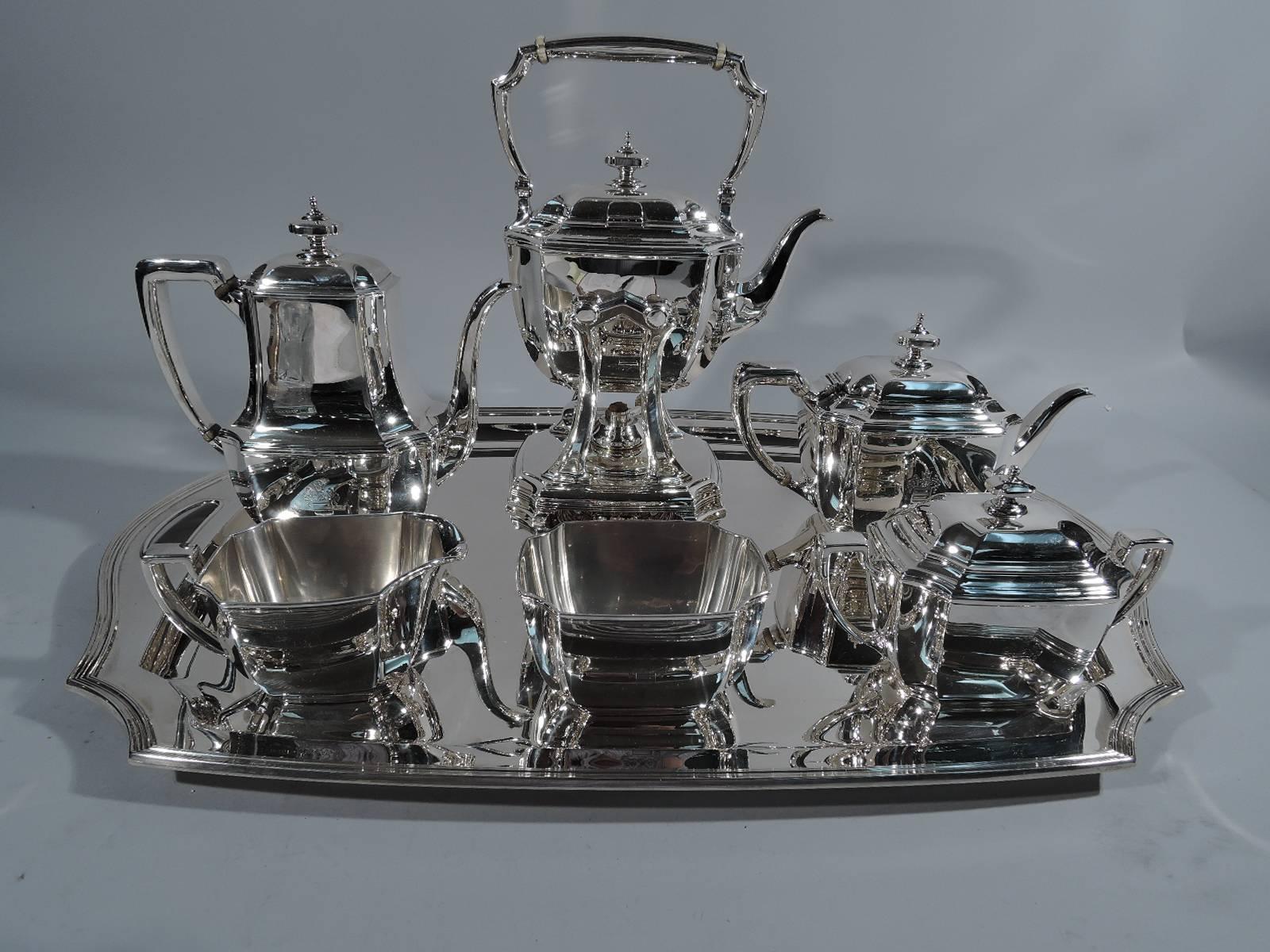 Sterling silver coffee and tea set in Hampton pattern. Made by Tiffany & Co. in New York, circa 1912. This set comprises kettle on stand, coffeepot, teapot, creamer, sugar, and waste bowl.

Rectilinear with curved sides, concave corners, and