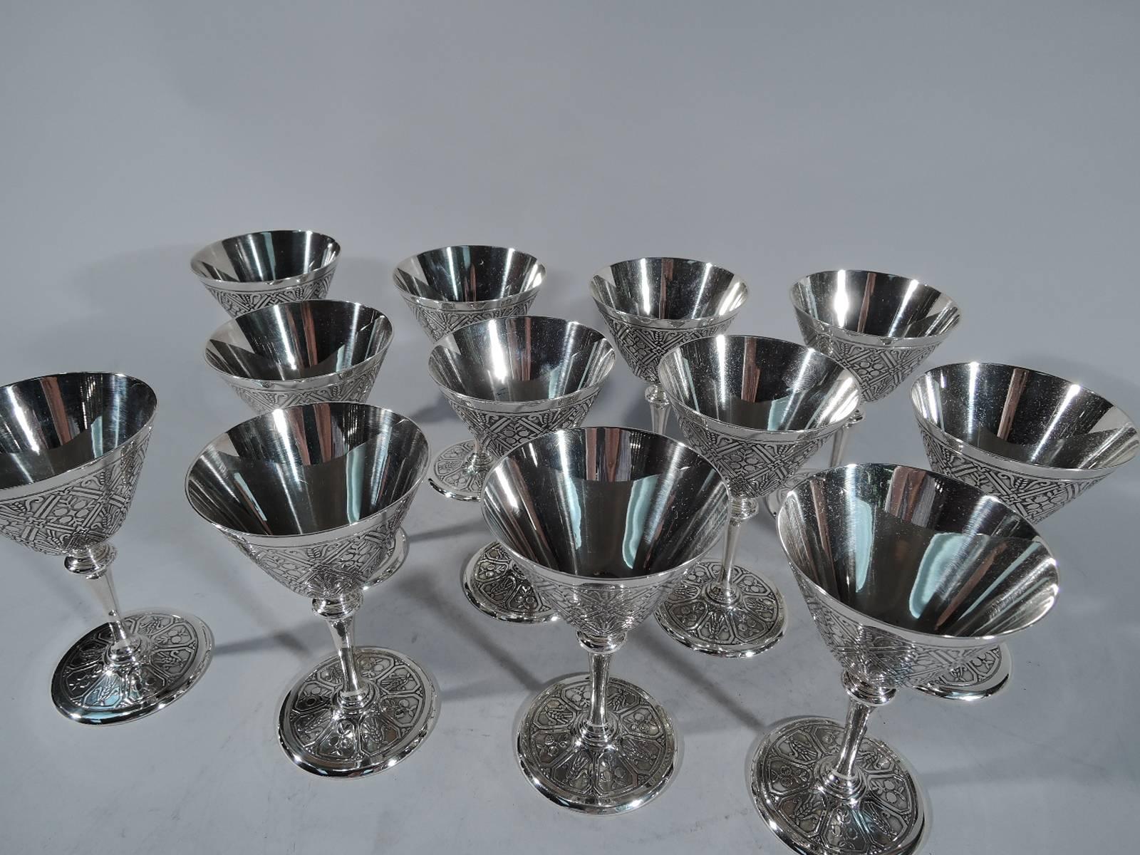 Set of 12 fabulous Art Deco sterling silver cocktail cups. Made by Tiffany & Co. in New York, circa 1922. Each: Conical bowl, tapering stem and flat foot. Bowl exterior and foot have acid-etched lattice inset with pertinent grain motif. Hallmark