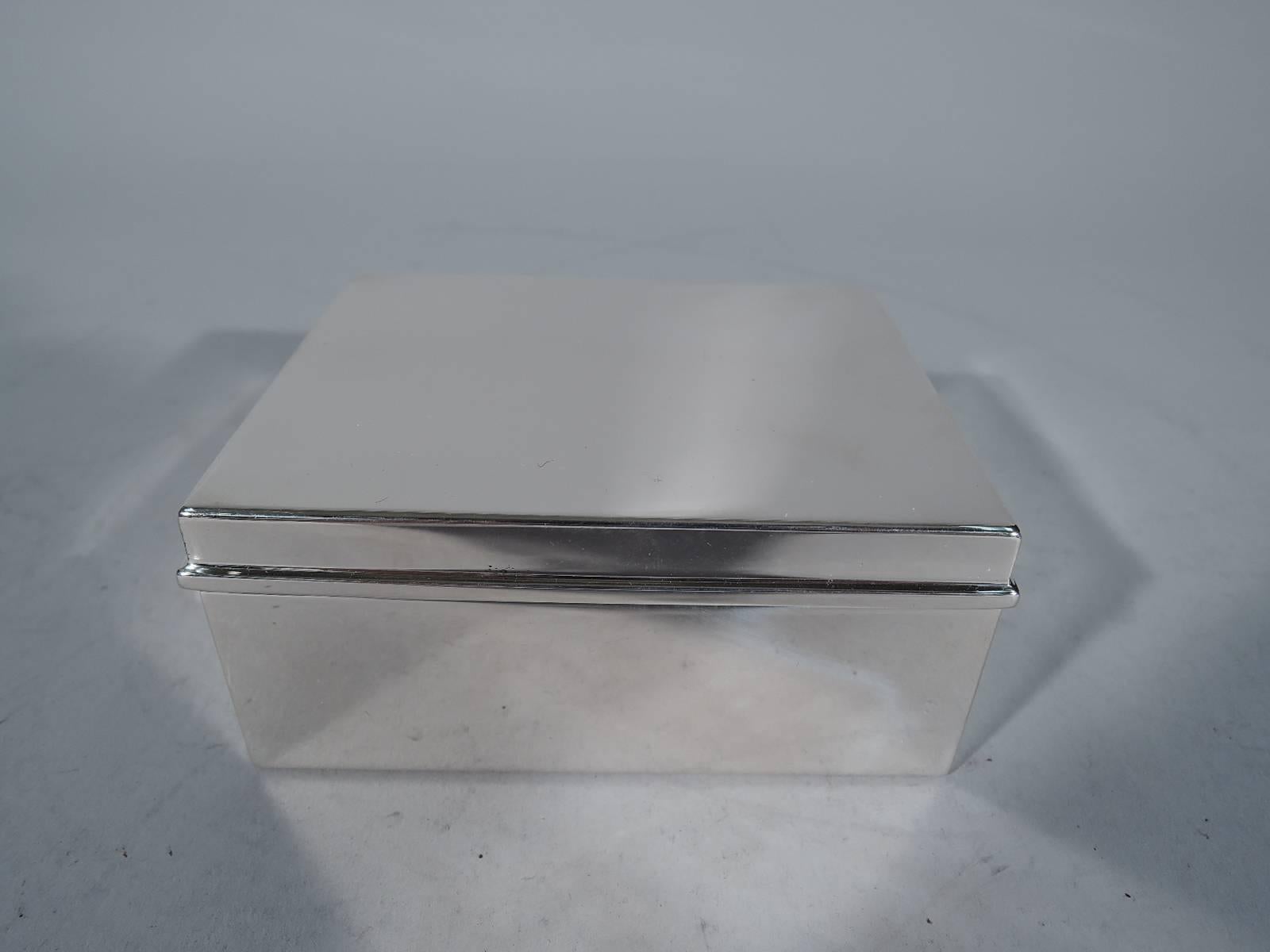 Modern sterling silver box. Made by Tiffany & Co. in New York. Rectangular with straight sides. Cover hinged and flat with molded rim. Box interior cedar-lined. Cover interior gilt. Hallmark includes pattern no. 22355 and director’s letter M
