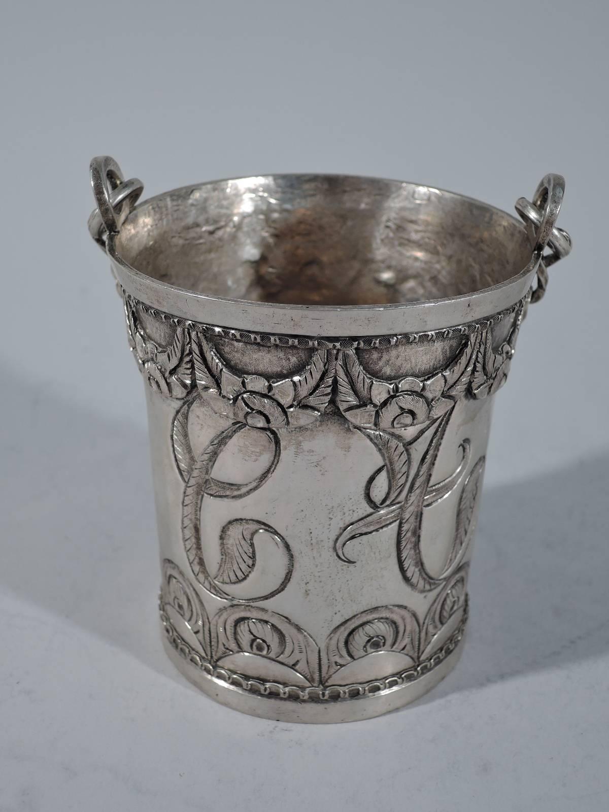 Nice quality Antique South American silver incense burner. Pail with applied garland at rim and chased and engraved peacock eye feather at base. Large three-letter monogram integrated into design. Chain handle attached to rim-mounted pierced rings.