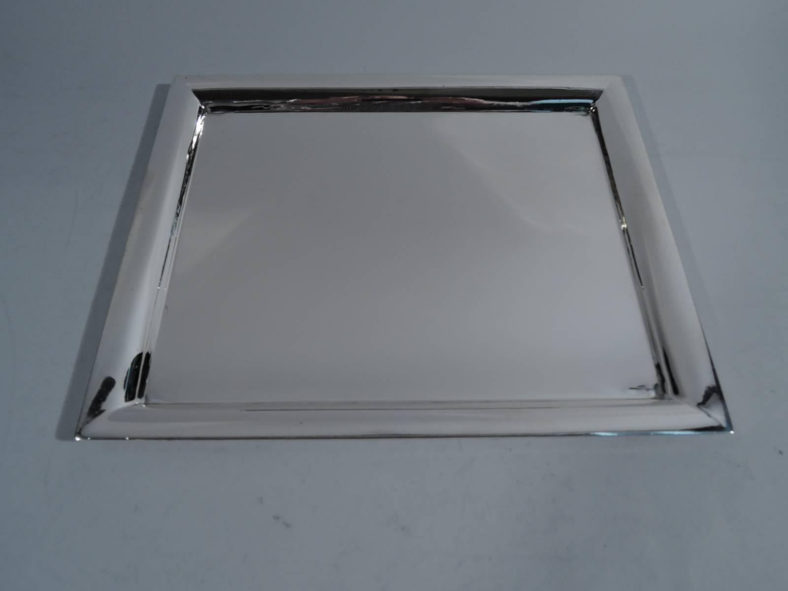 Sharp and crisp sterling silver tray. Made by Tiffany & Co. in New York, circa 1930. Rectangular with well and angular corners. Hallmark includes pattern no. 51041 and director’s letter m (1907-47). Heavy weight: 21.7 troy ounces.