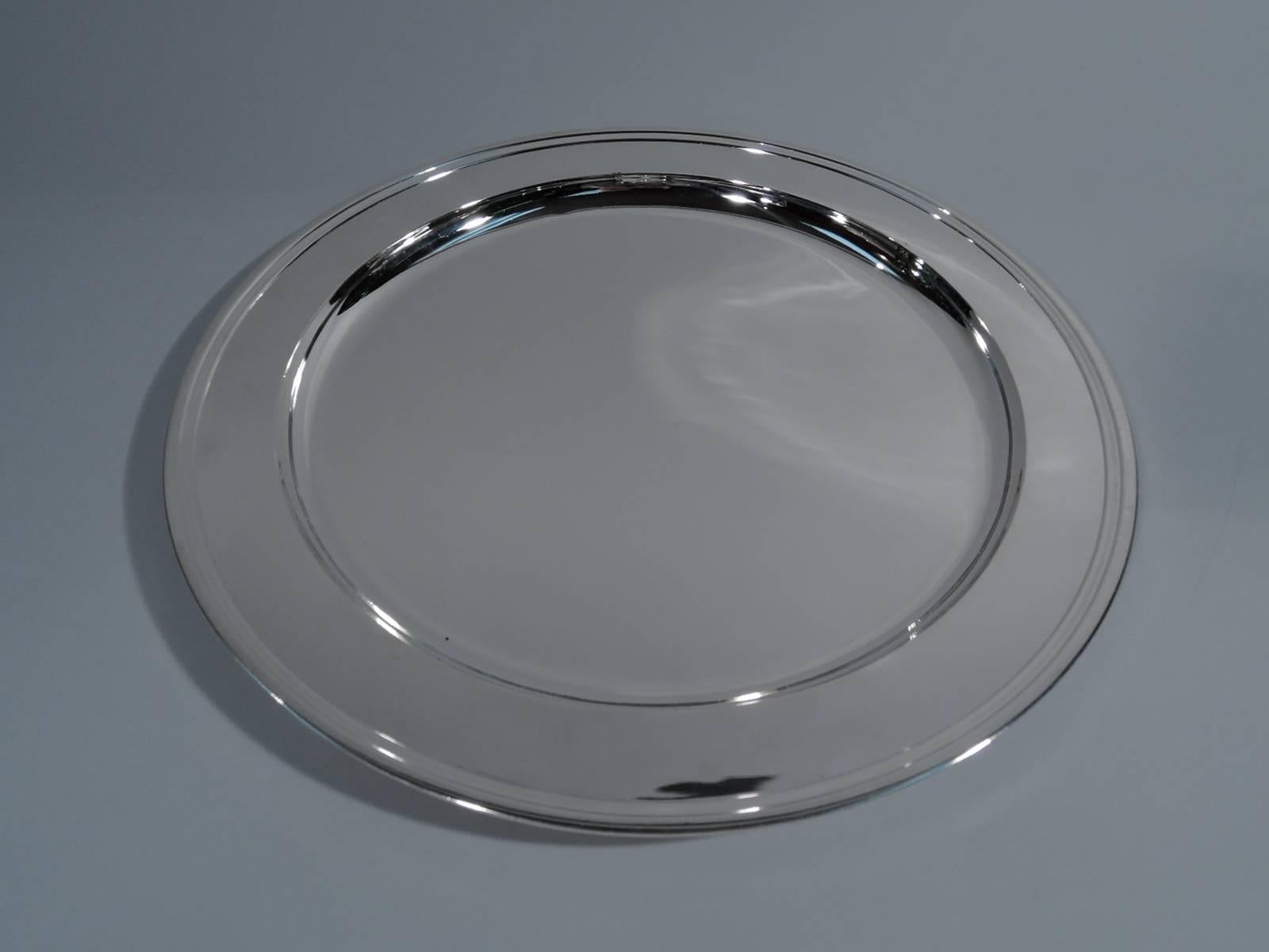 Sterling silver tray. Made by Tiffany & Co. in New York, circa 1923. Circular with deep well. Hallmark includes pattern no. 20188 (first produced in 1923) and director's letter m (1907-1947). Weight: 24 troy ounces.