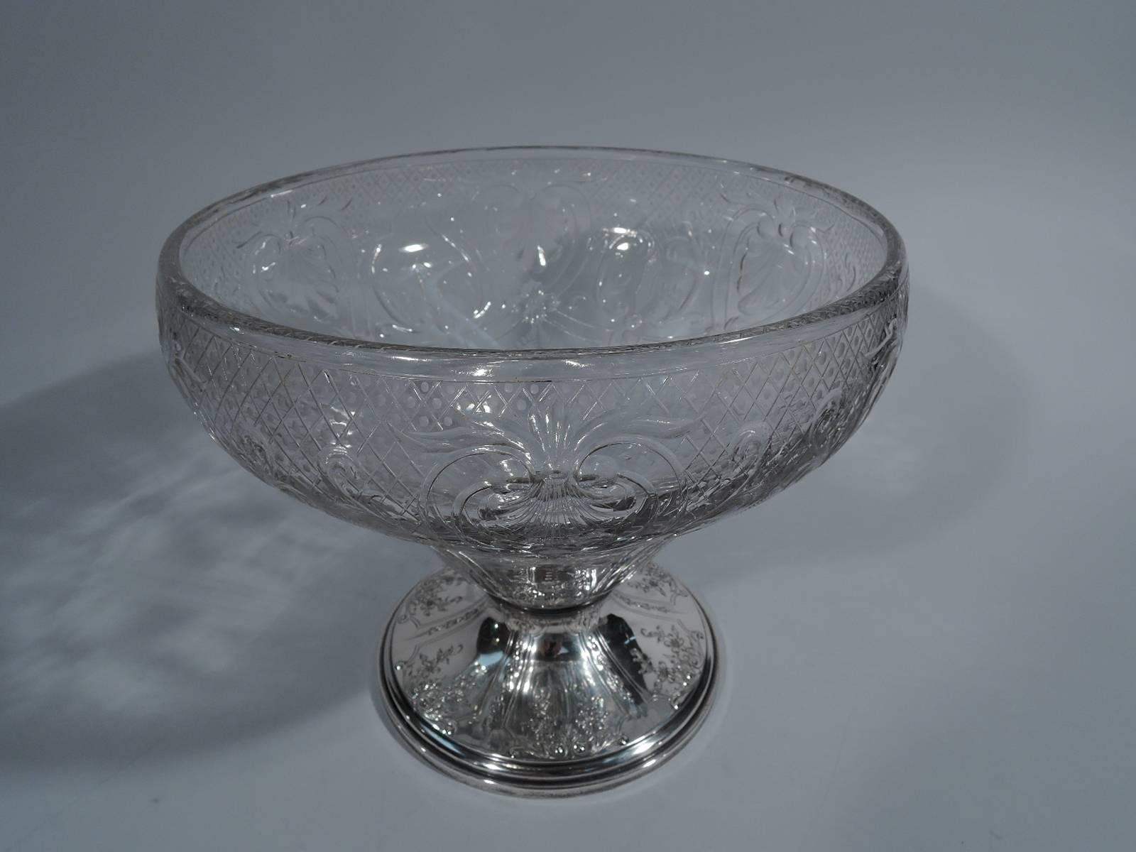 Edwardian sterling silver and crystal centrepiece bowl. Made by Gorham in Providence, circa 1910. Tapering crystal bowl with finely engraved diaper pattern, scrolls, and palmettes as well as acid-etched garlands. Raised foot has flowers set in