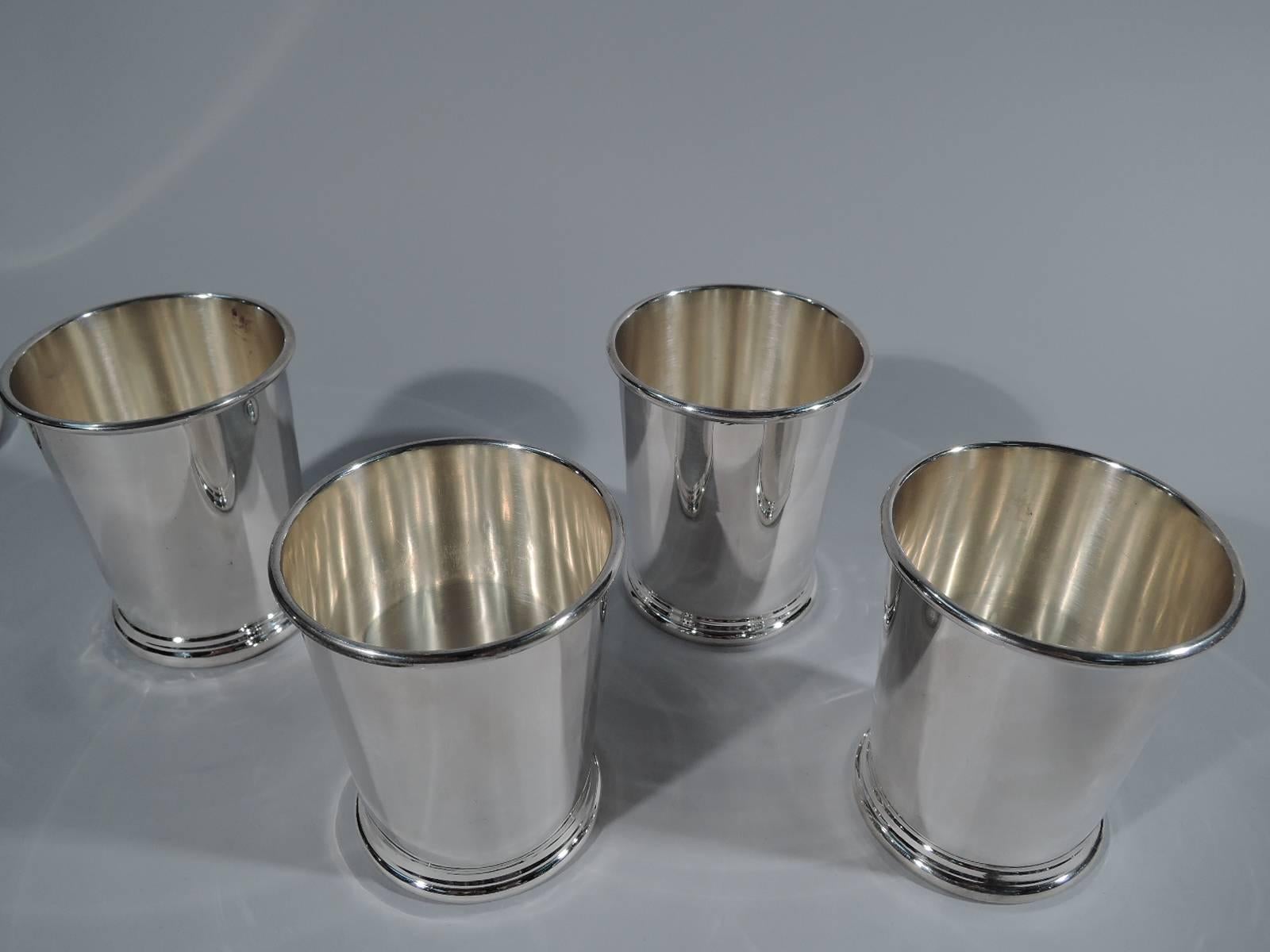 Set of four sterling silver mint juleps. Made by Preisner in Wallingford, Conn. Each: Straight and tapering sides, molded rim, and skirted base. Hallmark includes no. 140. Total weight: 18 troy ounces.