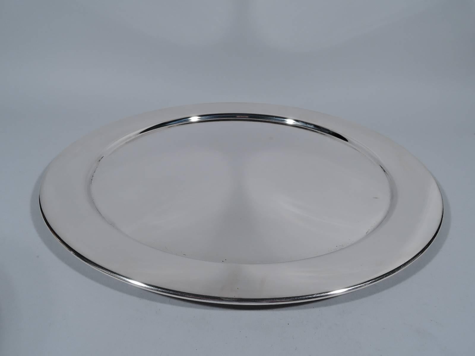 Sterling silver serving tray. Made by JC Boardman in Wallingford, Conn., circa 1950. Circular with deep well and flat rim. Hallmark includes no. 436. Heavy weight: 48 troy ounces.