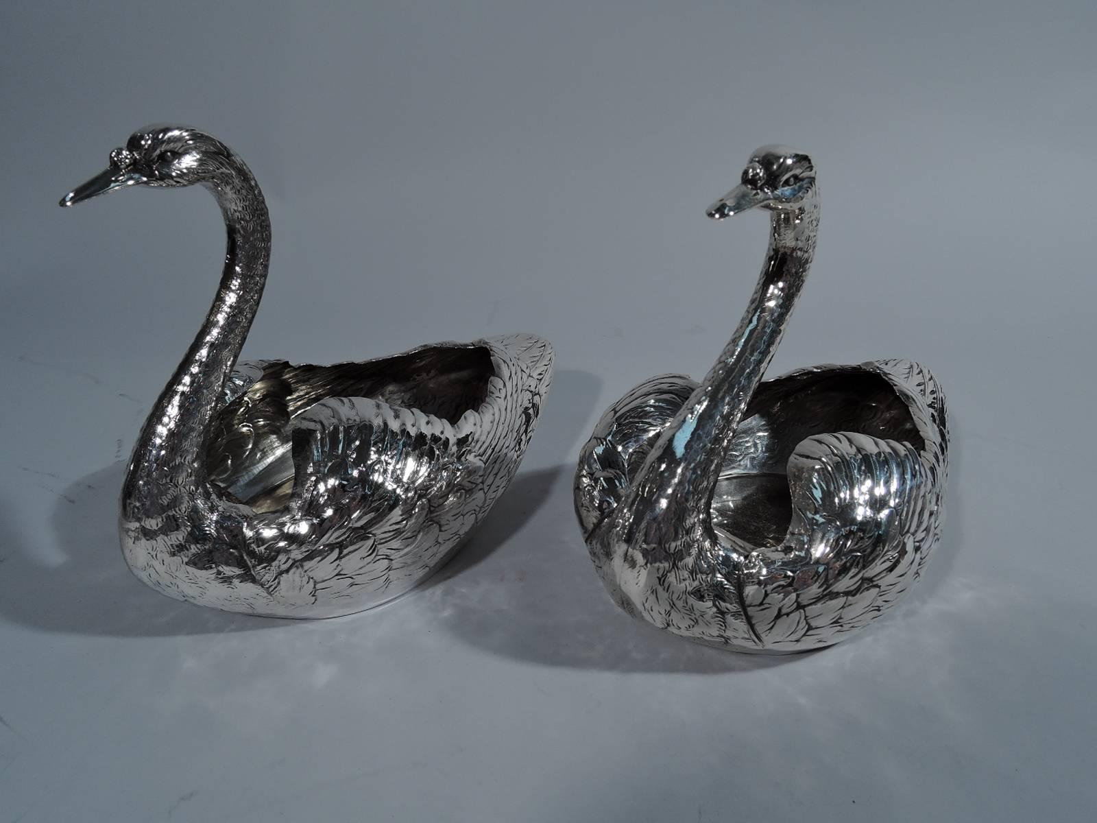 Pair of sterling silver swans. Made by Durgin (part of Gorham) in Concord, New Hampshire, circa 1915. Each: distinctive feathering with downy plumed wings and scaly neck as well as closed bill and penetrating eyes. Hollow bodies waiting to be filled