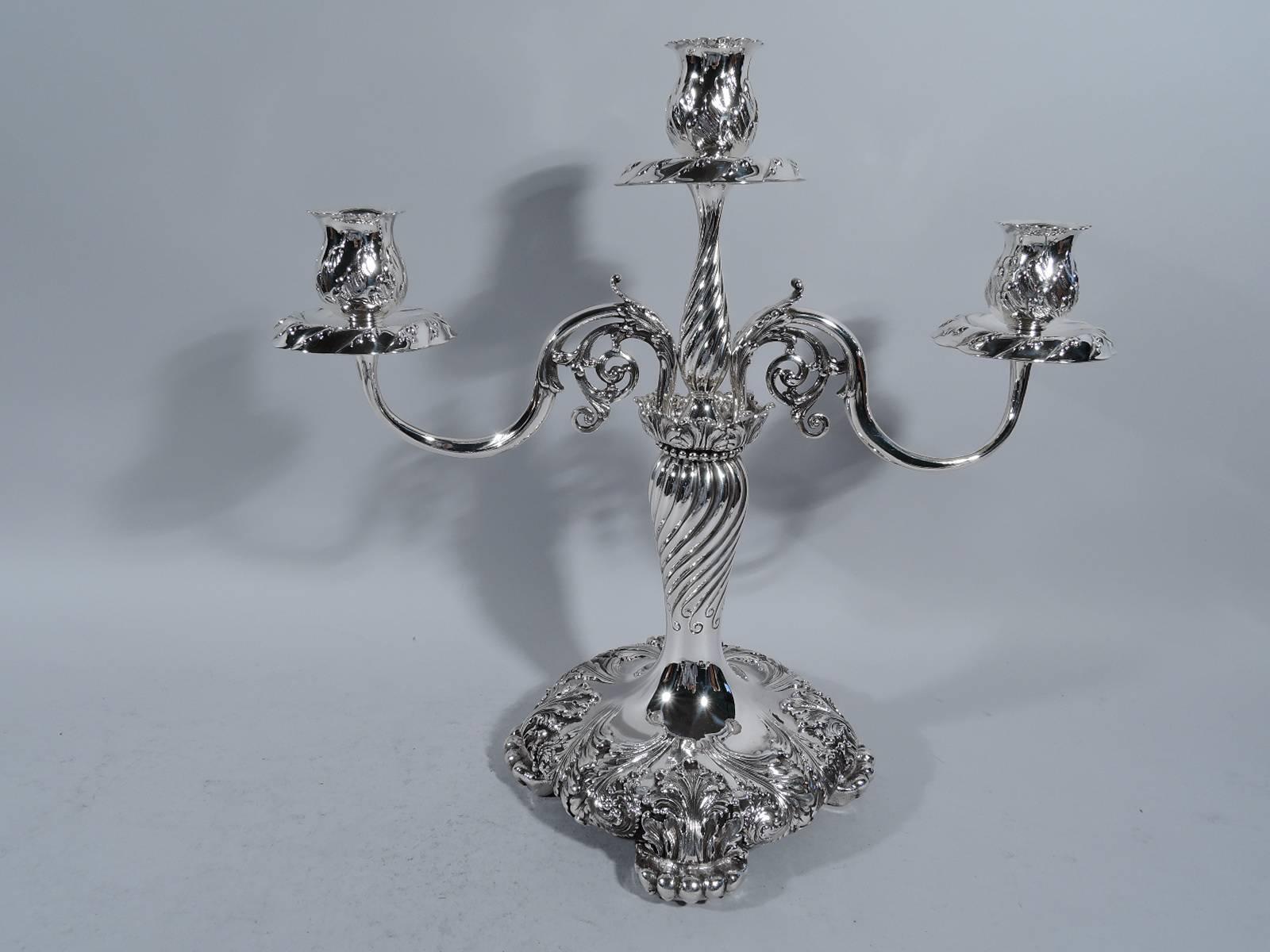 Pair of sumptuous sterling silver three-light candelabra. Made by Tiffany & Co. in New York, circa 1900.

Each: baluster shaft on raised round base with 4 clawed paw supports. Shaft surmounted by upward tapering baluster shaft set in beaded leaf