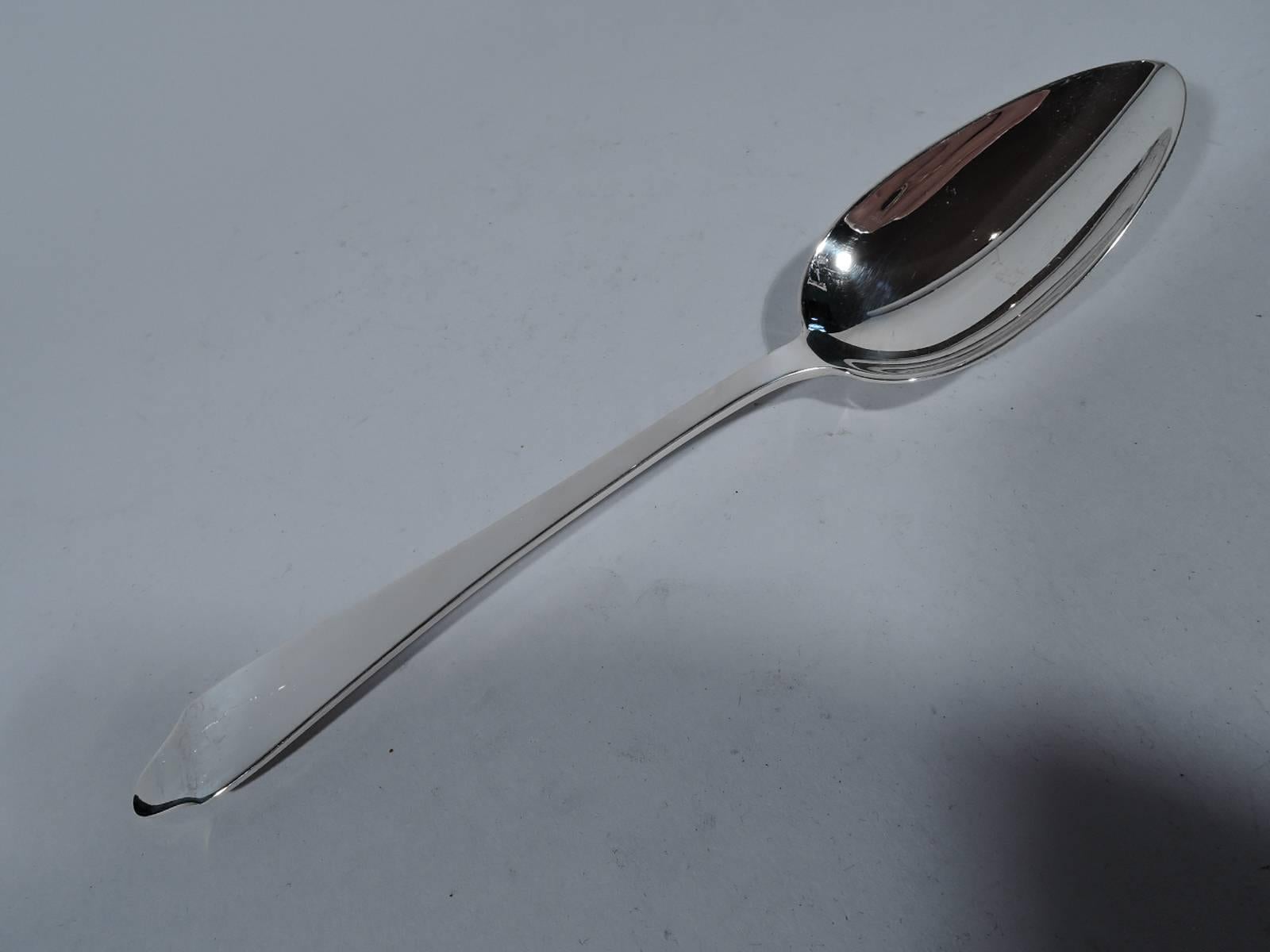 Pair of sterling silver serving spoon and fork in Clinton pattern. Made by Tiffany & Co. in New York. Two fine pieces in a distinctive pattern that works with both Colonial Revival and Art Deco table settings. The pattern was first produced in