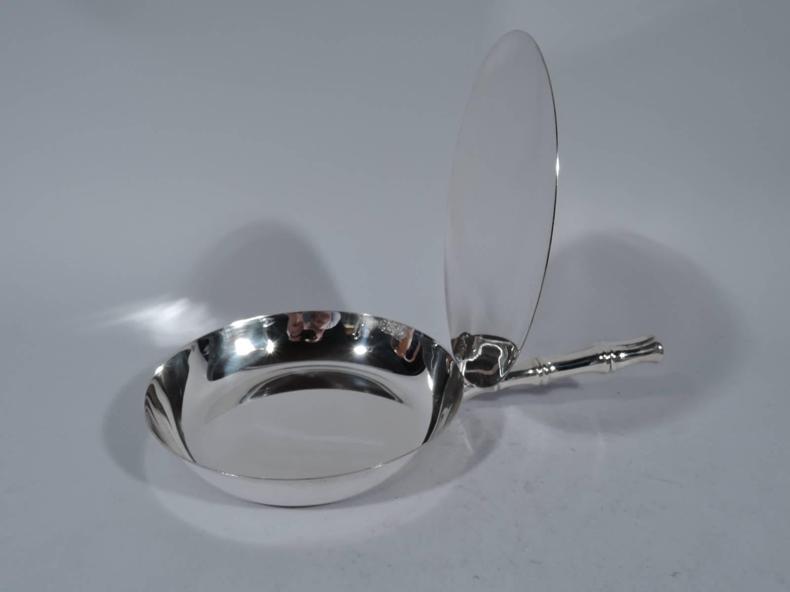 Sterling silver silent butler in bamboo pattern. Made by Tiffany & Co. in New York, circa 1965. Shallow bowl with curved sides. Cover flat and hinged with fluted thumb rest. Handle bamboo form. A rare and desirable piece in this pattern. Hallmark