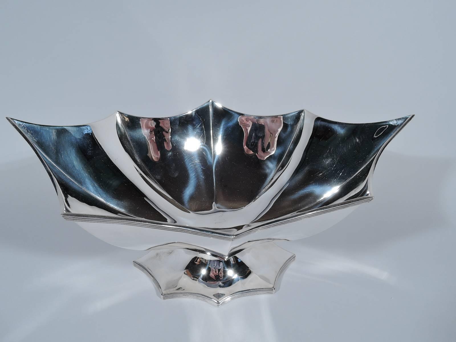 Modern sterling silver bowl. Retailed by Tiffany & Co. in New York. Deep and ovoid bowl with faceted and concave sides and reeded rim. End points elongated. Foot same. Hallmarked “Tiffany & Co Sterling Portugal”. Weight: 33.2 troy ounces.