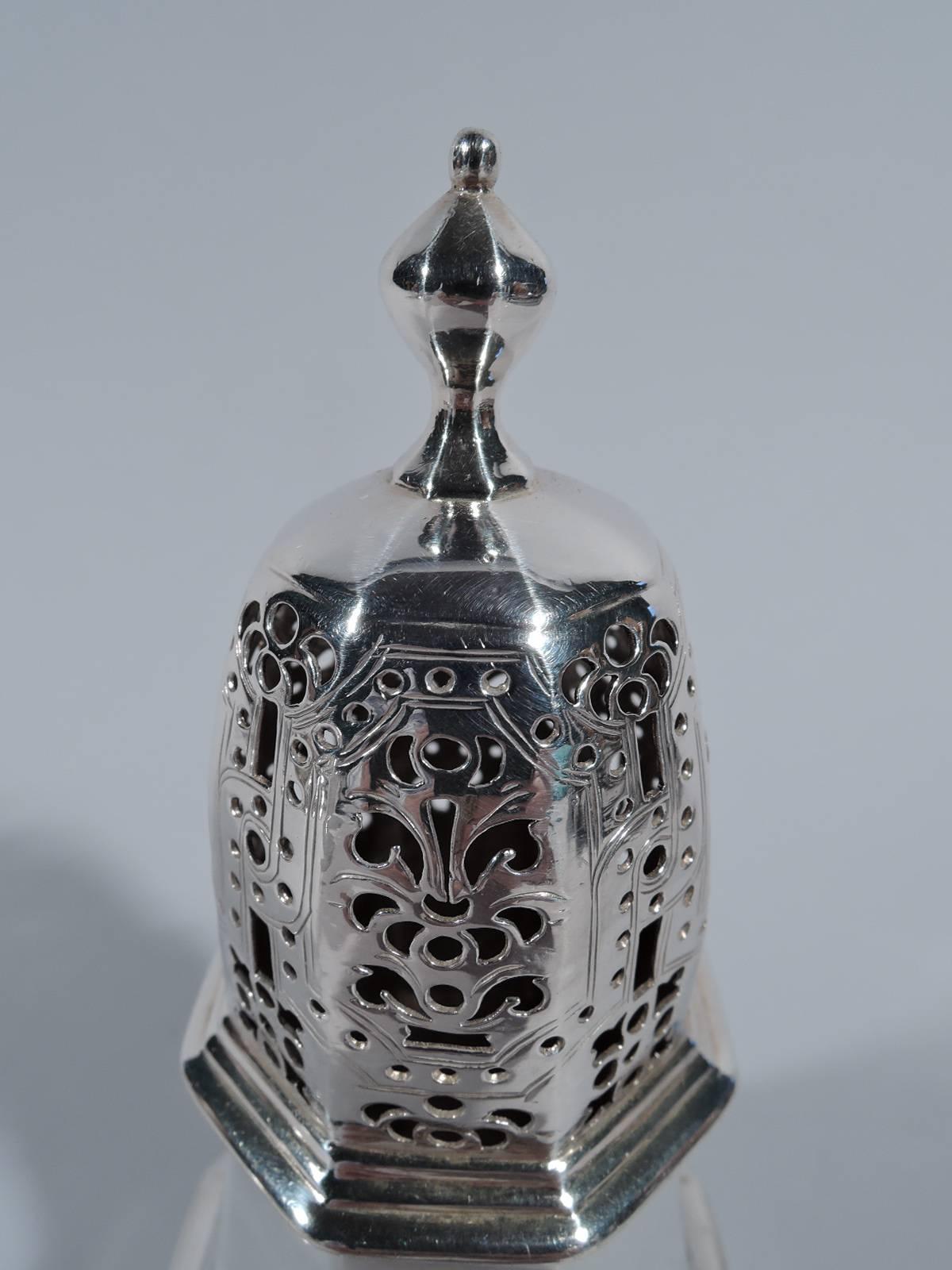 George I sterling silver sugar Shaker. Made by Charles Adam in London in 1719. Faceted baluster on raised faceted foot. Cover has ornamental piercing and finial. Hallmarked. Weight: 4.4 troy ounces.