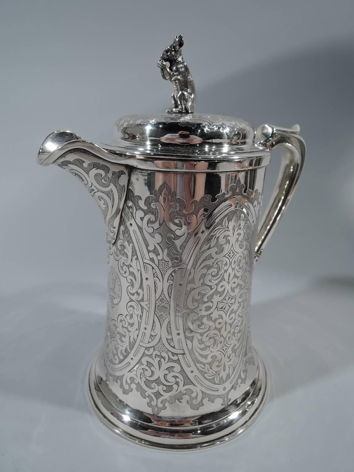 Victorian sterling silver coffeepot. Made by John Mitchell in Glasgow in 1862. Straight sides with spread base, capped scroll bracket handle, and hinged cover with squirrel finial. Scroll pattern in oval frames on shaded ground. An exciting period