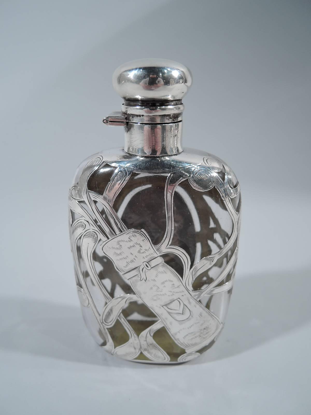 American clear glass flask with engraved silver overlay, circa 1900. Overlay in form of pell-mell clubs, some spilling out of bag and assorted balls. On front is a lady with windswept skirt and exposed ankles ready to swing. A great gift for the