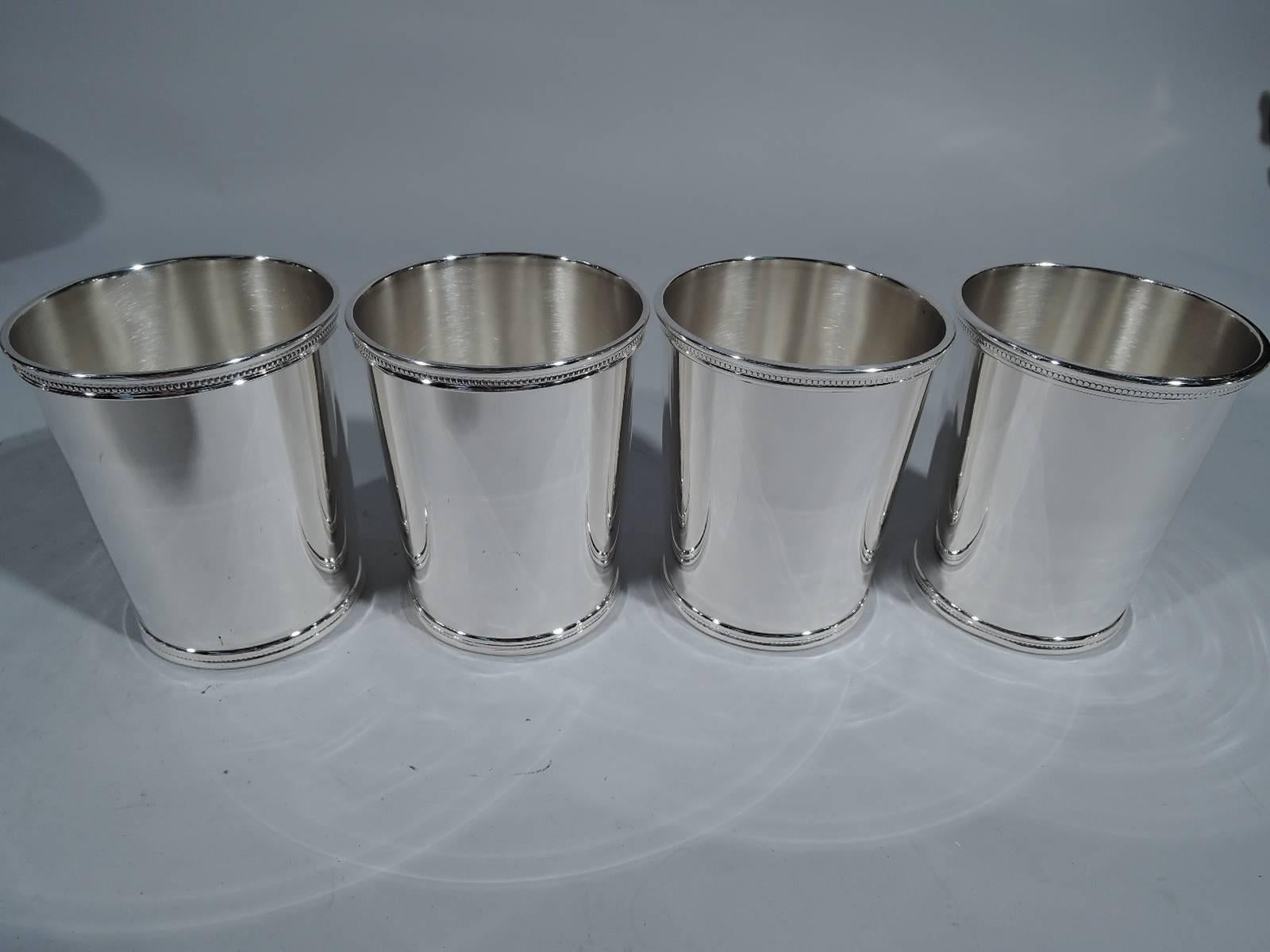 Set of 4 Eisenhower-era sterling silver mint julep cups. Made by Scearce in Shelbyville, Kentucky, 1953-1961. Each: straight and tapering sides and beaded and molded rims. A great set for Derby day or after a round of golf. Hallmark includes date
