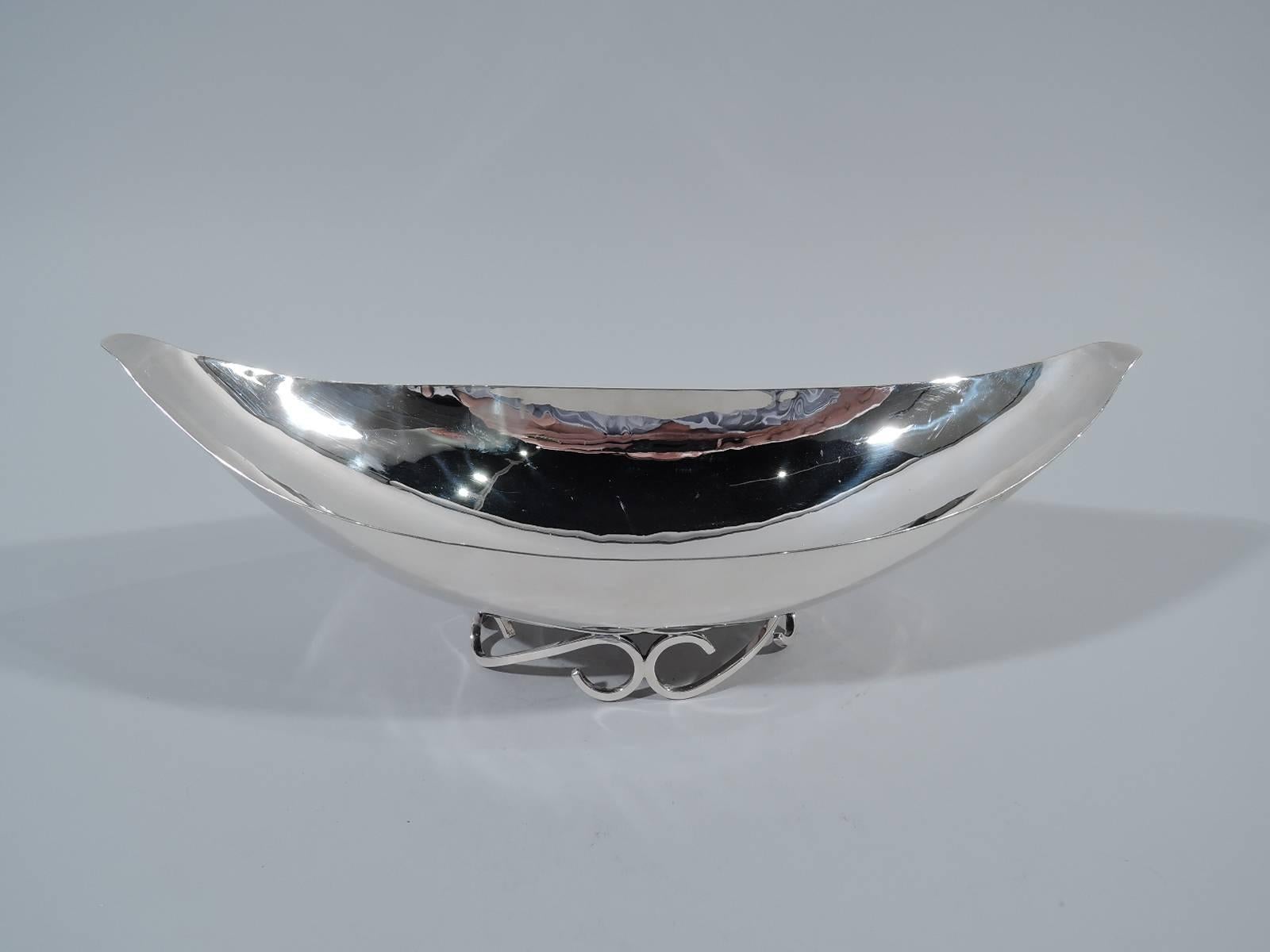 Mid-Century Modern sterling silver bowl. Made by Alfredo Sciarotta in Newport, Rhode Island. Gondola form with tapering ends. Visible hand-hammering. Rests on two joined and open s-scroll supports. Hallmark includes no. 93 and phrase “handmade”.