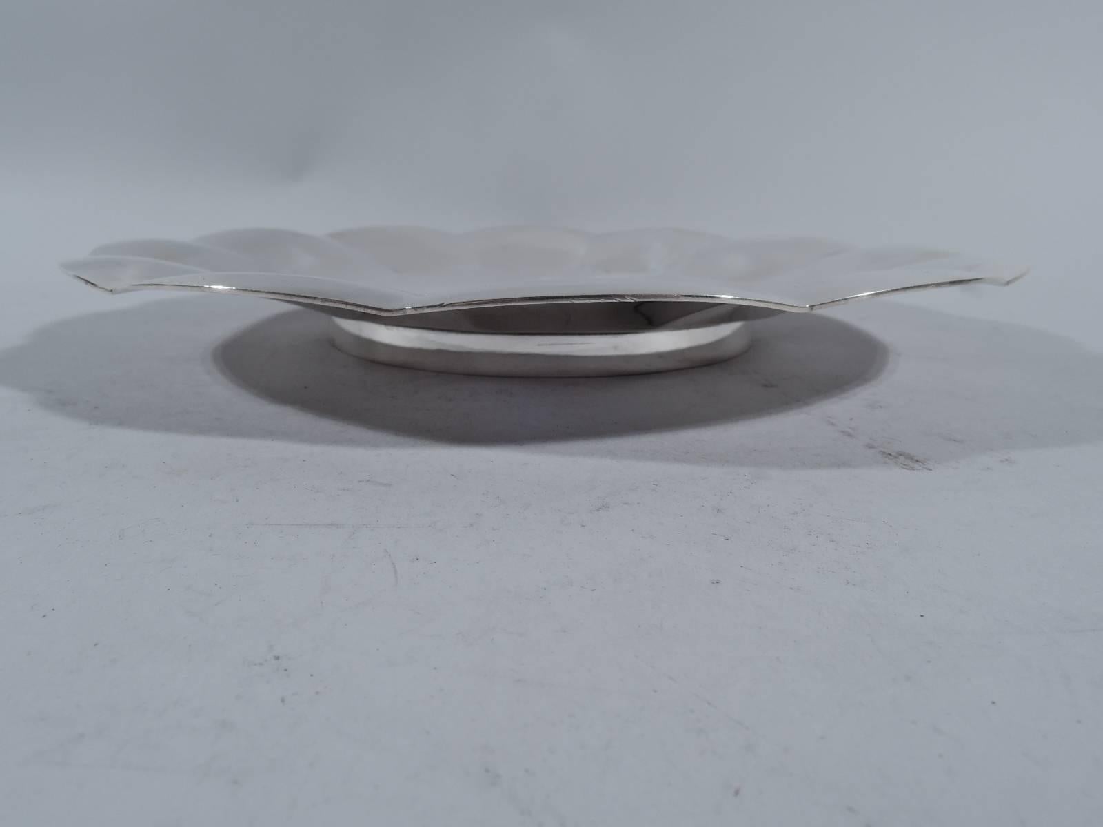 Modern sterling silver cake plate. Made by Tiffany & Co. in New York, circa 1940. Flat well and sloping sides with wide convex petals and shallow scalloping. Rests on short straight foot. Hallmark includes pattern no. 22929 (first produced in 1940).