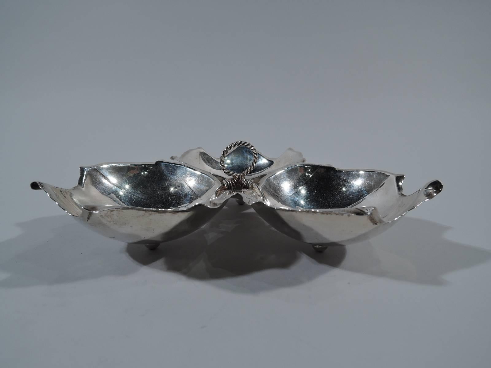 Mid-Century Modern sterling silver chip-and-dip. Made by Alfredo Sciarrotta in Newport, Rhode Island. Three-leaf-form bowls tied together with wire. Realistic veins and irregular point rims. Three ball supports. An iconic period piece. Hallmark