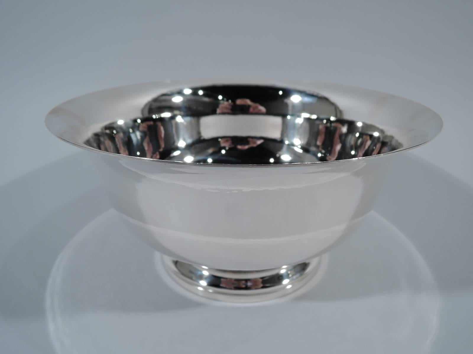Hand-hammered sterling silver Revere bowl. Retailed by Georg Jensen Inc. USA in New York. Traditional form with curved sides, flared rim, and stepped foot. Hallmarked by Worden-Munnis, a Boston maker that was founded in 1940 and specialized in