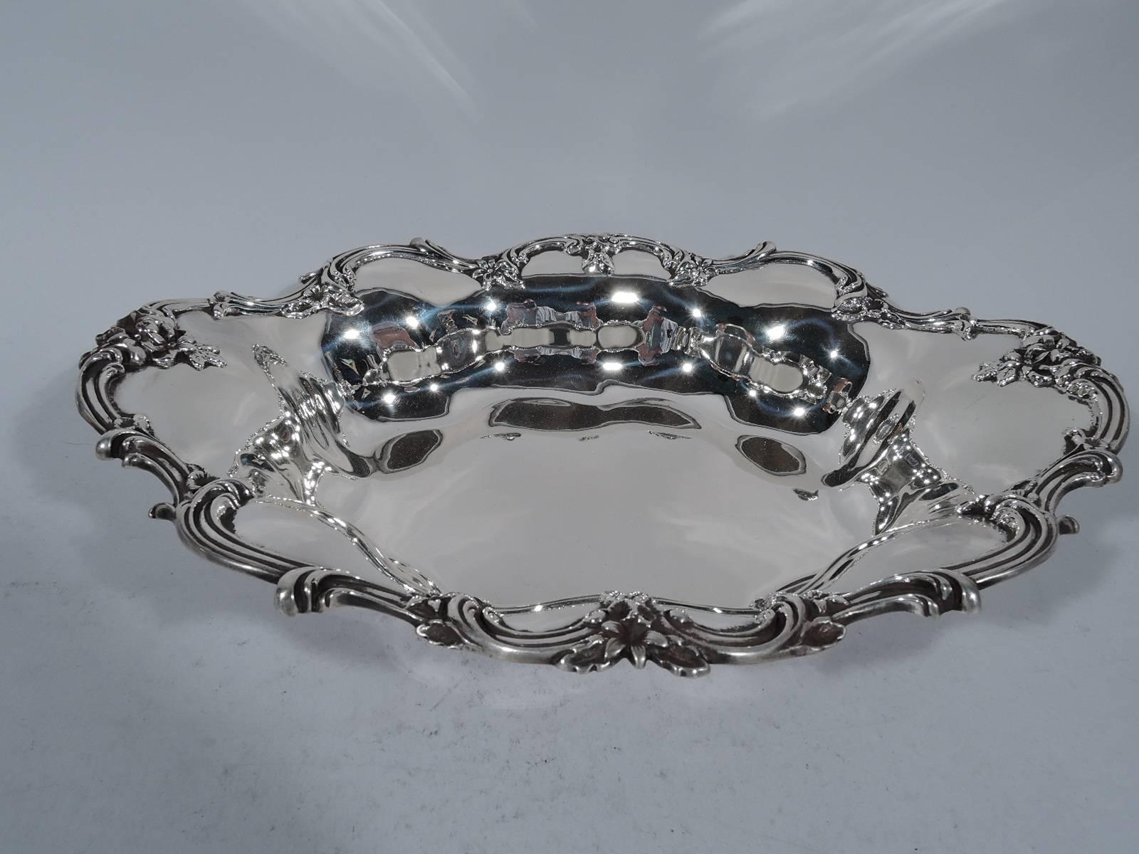 Sterling silver bowl. Made by Shreve, Crump & Low in Boston, circa 1900. Shaped well and lobed sides. Rim has applied scrolls and flowers. Hallmark includes no. 70S. Weight: 15.2 troy ounces.