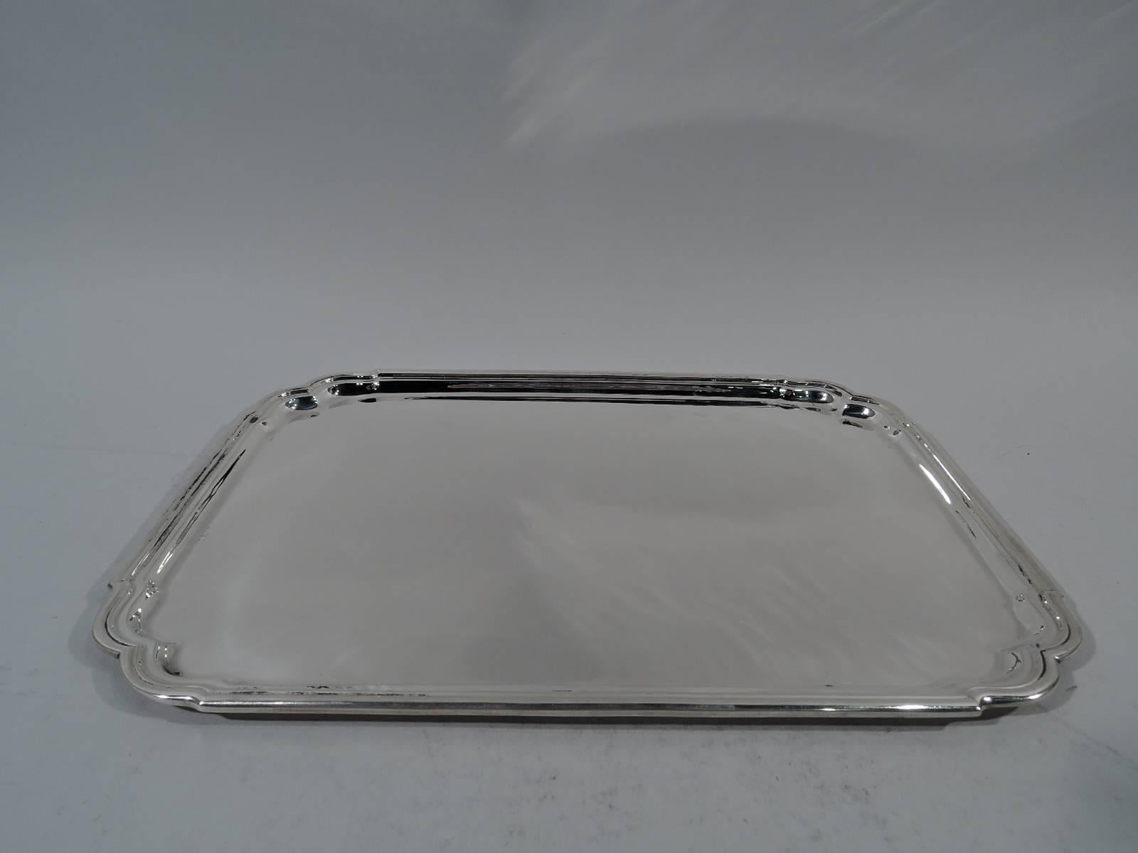 Georgian-inspired sterling silver tray. Made by Tiffany & Co. in New York. Rectangular with molded rim and double C-scroll corners. A great Midcentury take on 18th century design. Hallmark includes postwar pattern no. 23967. Measure: Weight 34.7