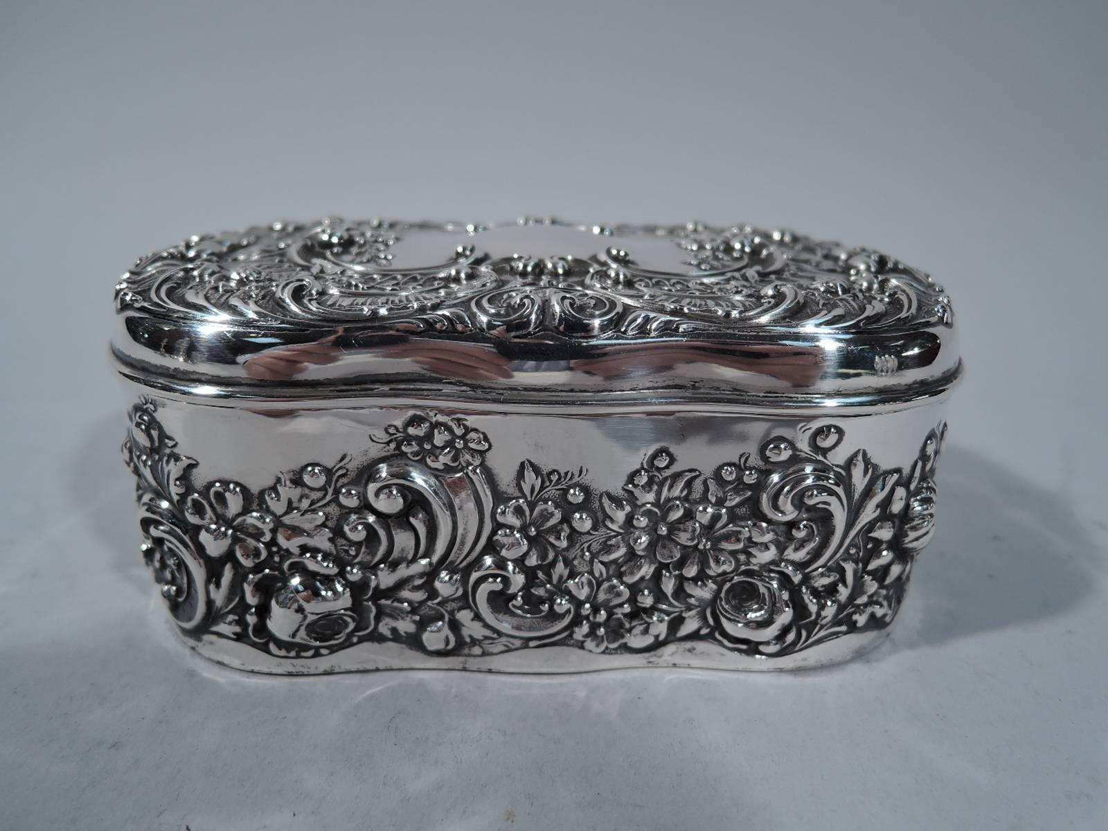 Sterling silver jewelry box. Made by Gorham in Providence in 1899. Shaped box with hinged cover. Repousse flowers, leaves and scrolls. Box bottom has distinctive wave border. Box cover has vacant scrolled cartouche it awaits the name of a special