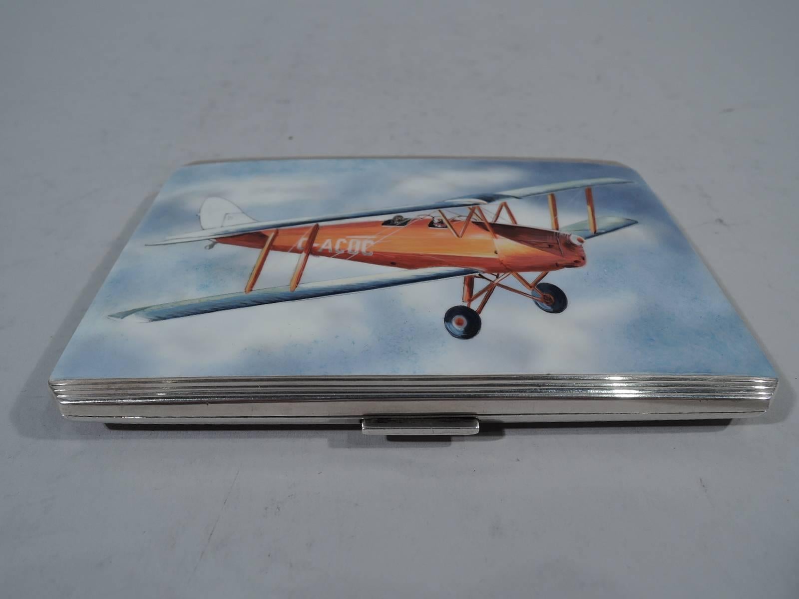Elizabeth II sterling silver and enamel cigarette case. Made by Willian Neale & Sons, Ltd in Birmingham in 1956. Rectangular and hinged with chamfered corners. On cover in enamel is an early two-seat airplane piloted through blue sky and fluffy