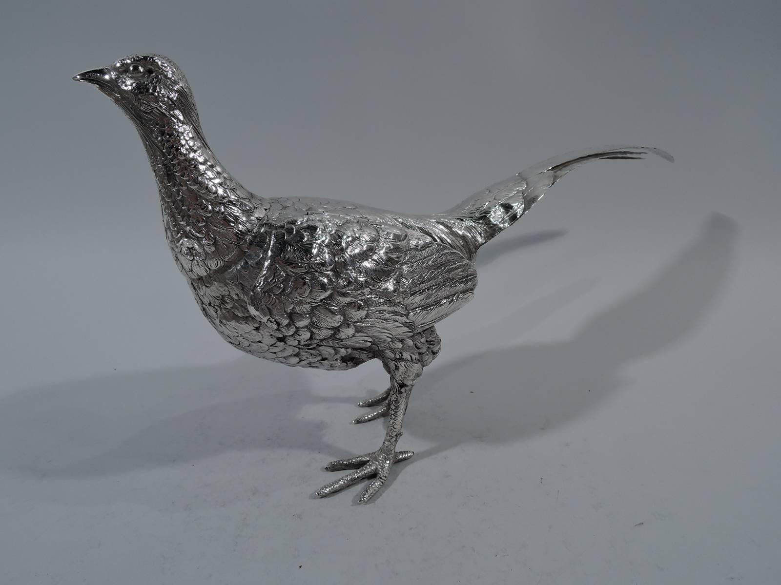 Antique German 800 silver bird-form spice box, circa 1900. A strutting pheasant with head high, wings close to body, tail erect, soft plumage, and scaly talons in mid stride. Detachable head and hinged wings. Hallmarked.

Measure: H 8 5/8 x W