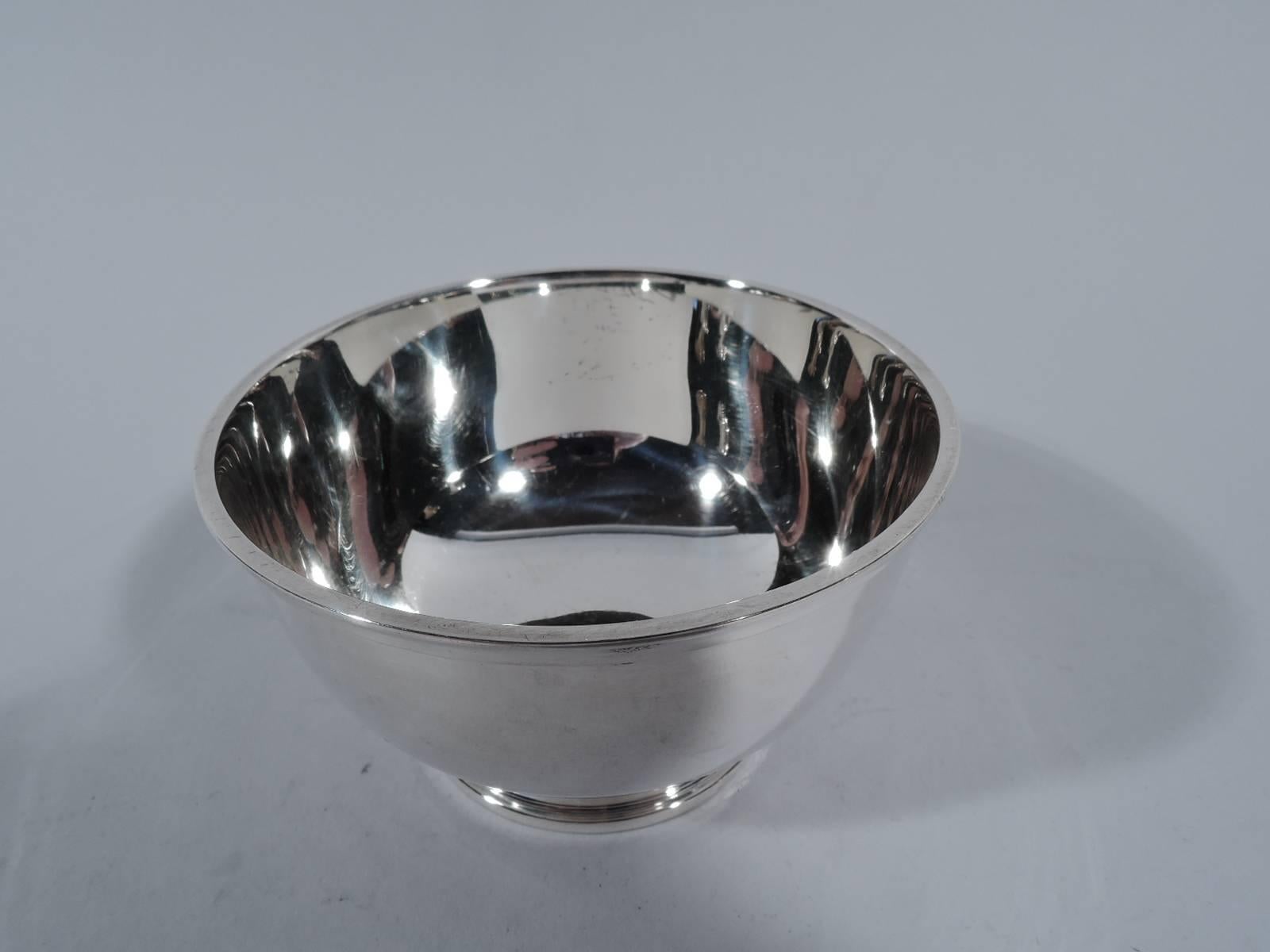 Sweet and small sterling silver bowl. Made by Tiffany & Co. in New York. Traditional Revere form with curved sides, molded rim, and stepped foot. Hallmark includes pattern no. 22938 and director’s letter M (1947-56). Weight: 4 troy ounces.