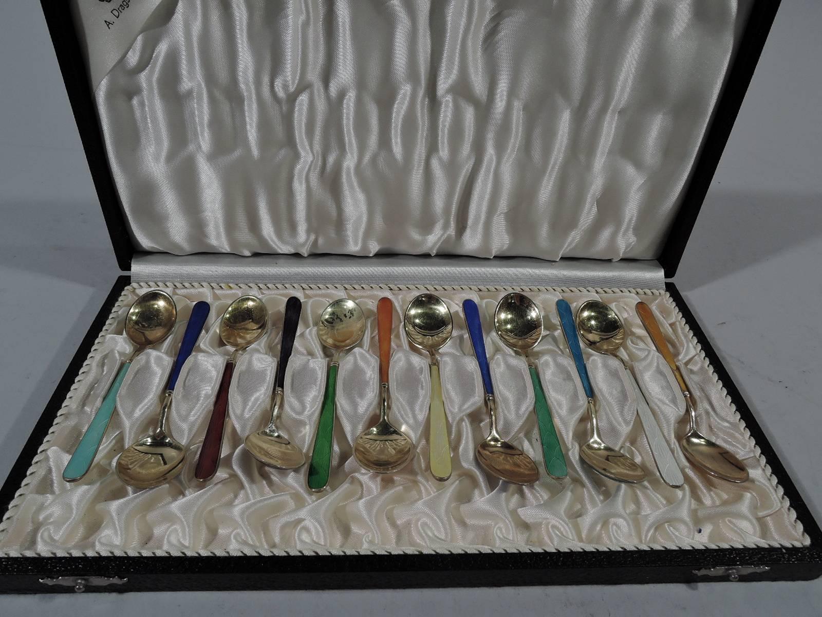 Set of 12 Danish Modern gilt sterling silver and enamel demitasse spoons. Made by A. Dragsted in Copenhagen. Each spoon has tapering handle with double-sided enamel and oval bowl with gilt interior and enameled underside. Enamel has imbricated fan