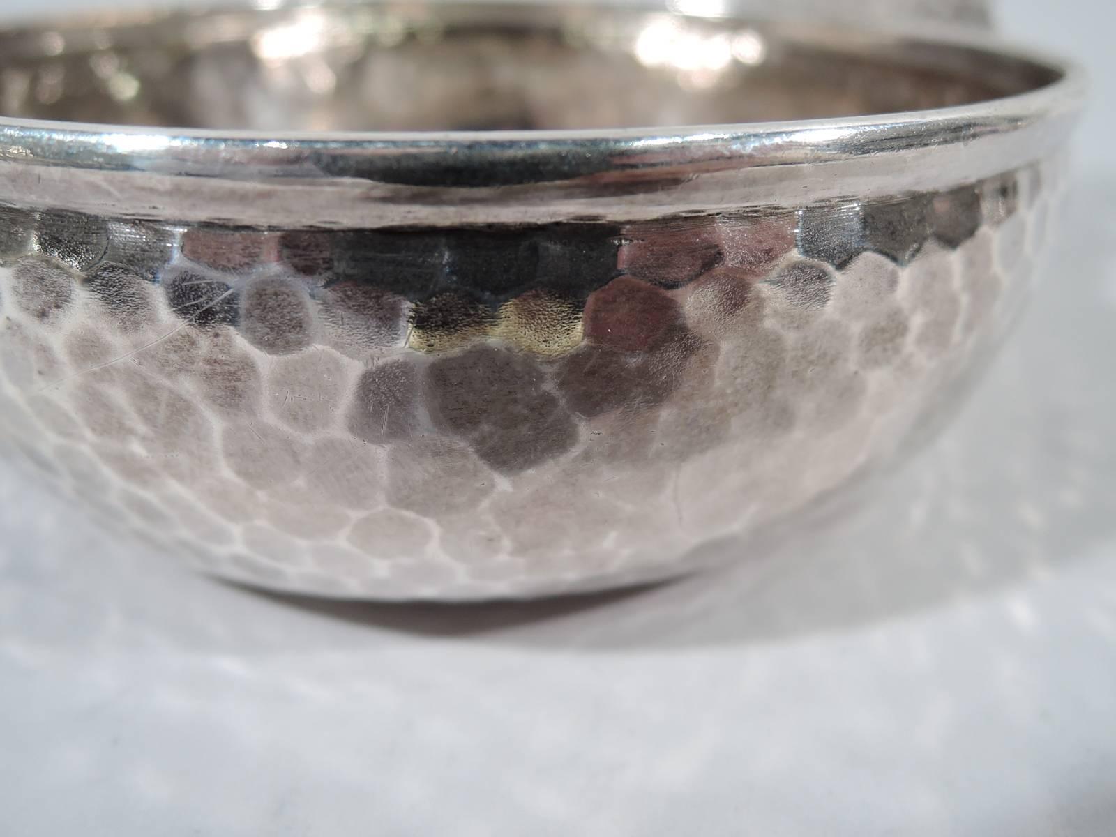 Craftsman sterling silver porringer. Made by Tiffany & Co. in New York, circa 1878. Traditional form with shaped open handle. Dense all-over fish-scale hammering. Very much a statement design. Hallmark includes pattern no. 5050 (first produced in