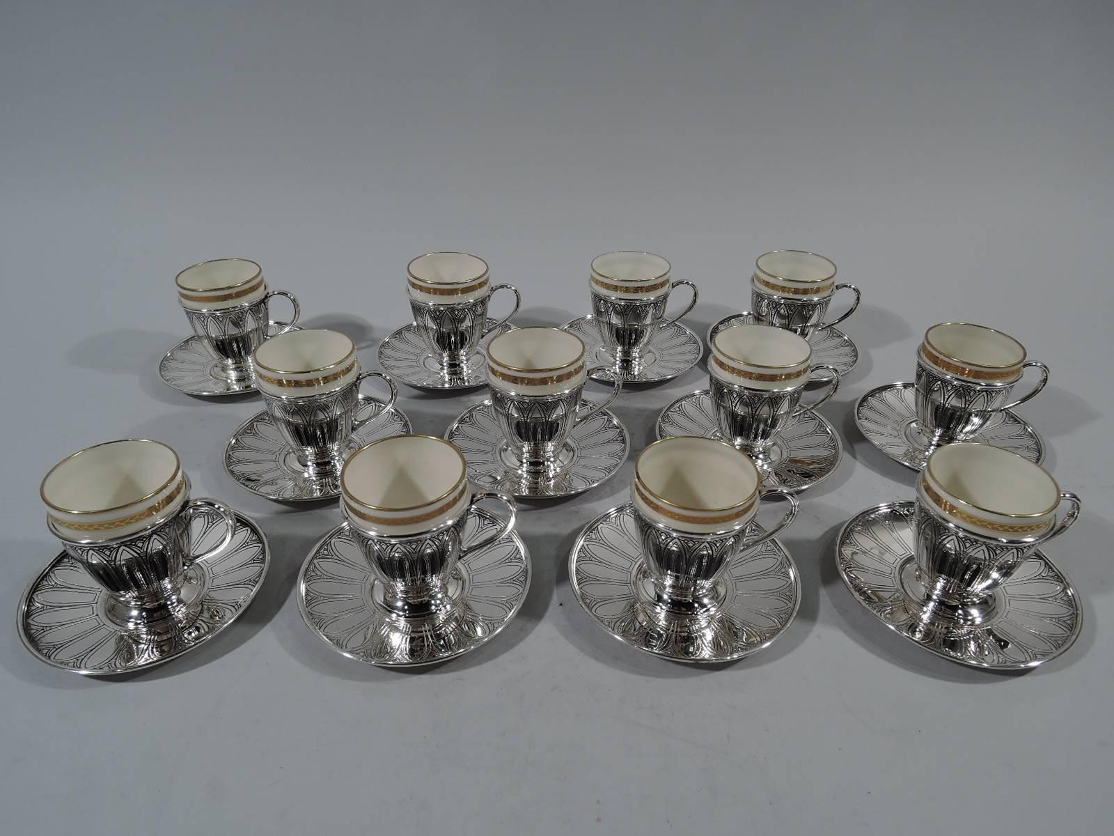 Set of 12 Art Deco sterling silver demitasse cup holders and saucers with 12 bone china liners. The holders and saucers were made by Tiffany & Co. in New York, circa 1923. The liners were made by Lenox in Trenton, New Jersey for Tiffany &