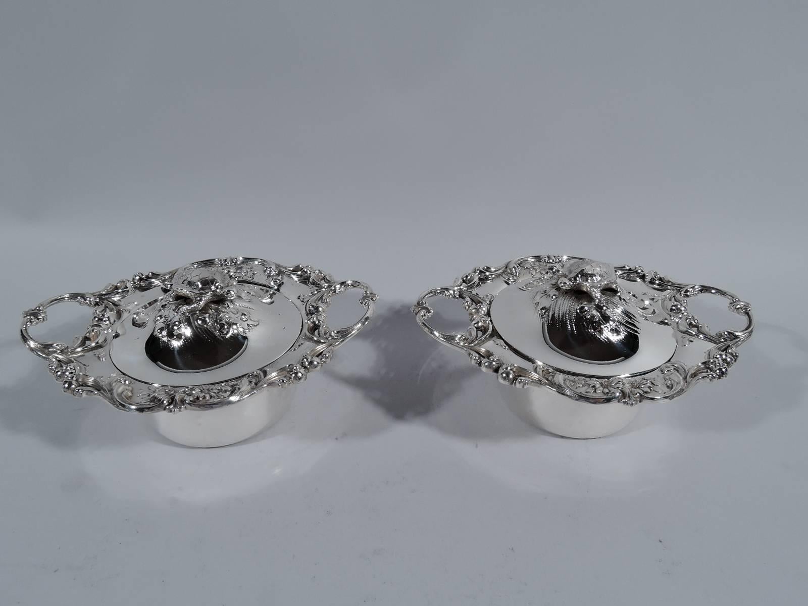 Set of 12 sterling silver covered soup bowls. Made by Redlich in New York, ca 1890. Each: Drum-form. Wide rim with applied scrolls and chased and repousse flowers and open scroll handles. Dome cover with cast turtle finial – an indication of what
