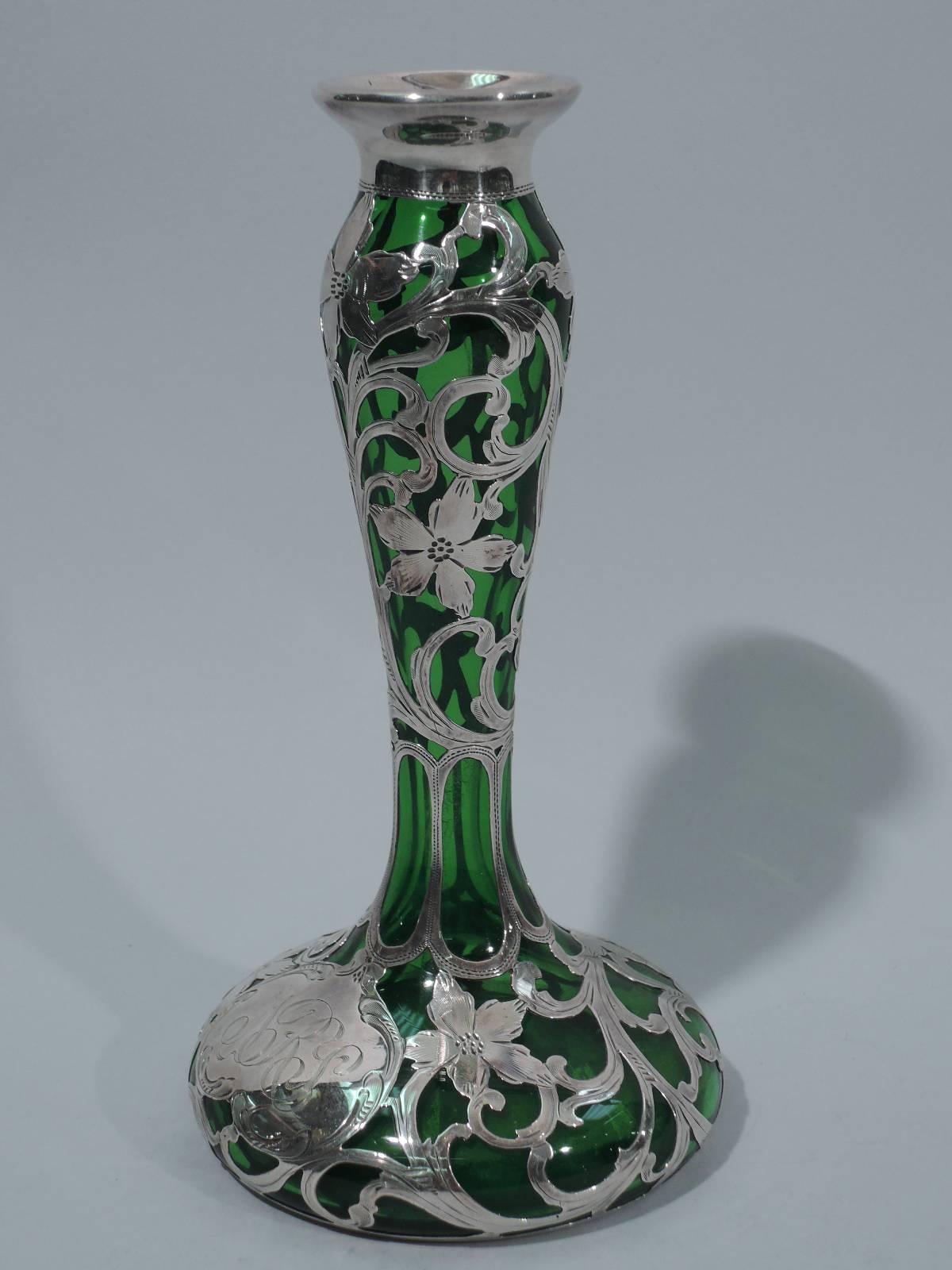 Art Nouveau emerald glass vase with silver overlay. Made by Alvin in Providence, circa 1900. Baluster on raised and round foot. Olive-ish glass overlaid with pretty silver flowers and scrolls. Scrolled cartouche has engraved script monogram. Flared