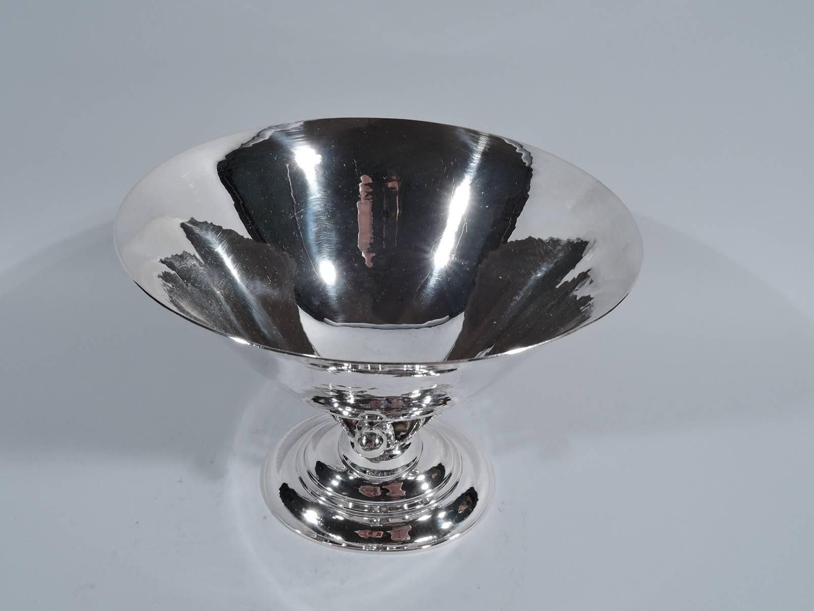 Early sterling silver bowl. Made by Georg Jensen in Copenhagen. Round bowl with tapering sides on abstract plant support: tendril terminating in bead and mounted to leaf alternating with tendril with two beads at base. Stepped oval foot. Visible