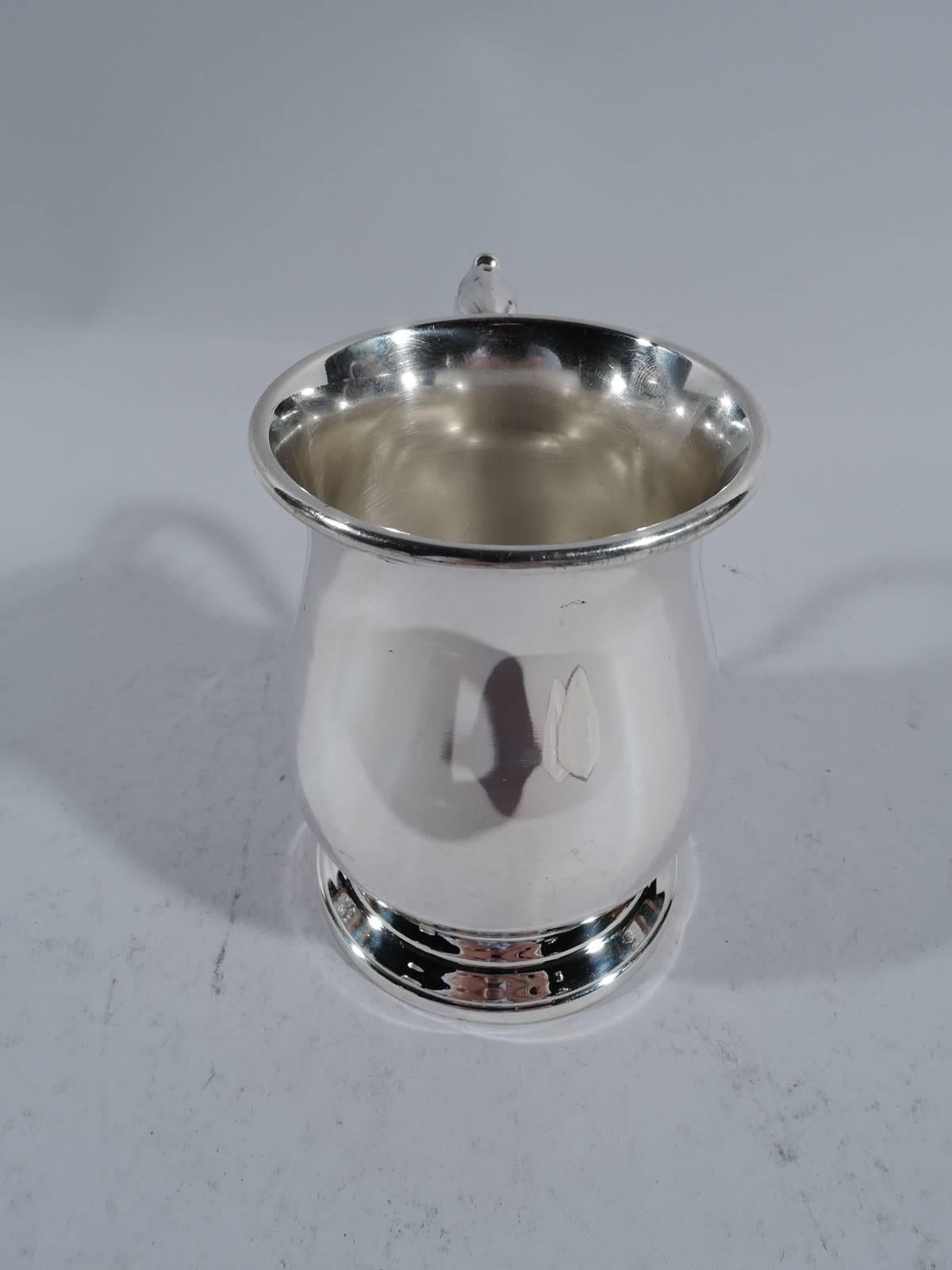 Sterling silver baby cup. Made by Manchester in Providence. Baluster body with capped s-scroll handle and spread foot. Lots of room for engraving. Marks include no. 22 and phrase Authentic reproduction / of Paul de Lamerie mug / 17th century