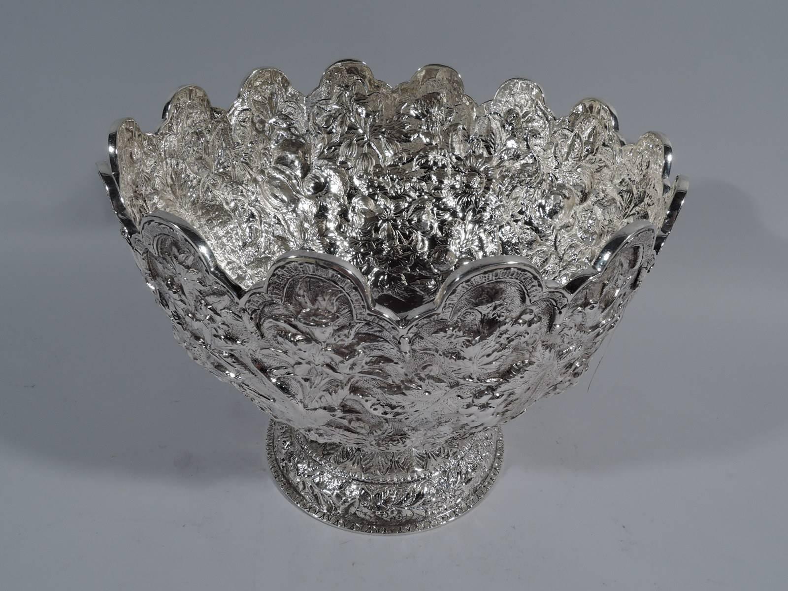 Repousse silver footed bowl. Made by S. Kirk & Son in Baltimore, circa 1880. Curved sides and raised foot. All-over repousse with fruits and flowers on stippled ground. Rim in form of trefoil arcade. A very nice-piece in the historic 11/12 (that is,