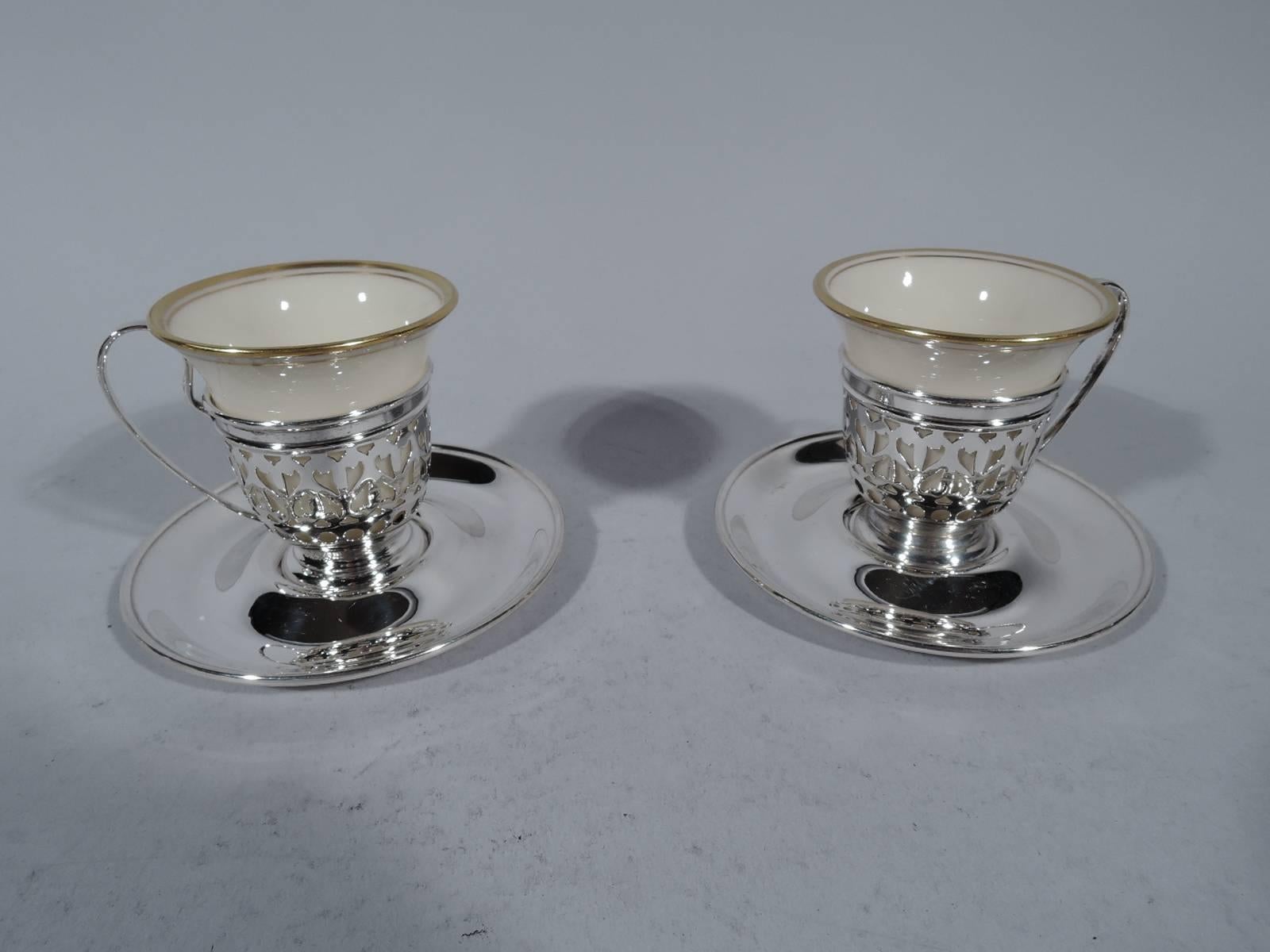 Set of 16 sterling silver demitasse cup holders and saucers with 16 bone china liners. The holders and saucers with made by Gorham in Providence, circa 1910. The liners were made by Lenox in Trenton, New Jersey.

Holder: Stepped foot and high