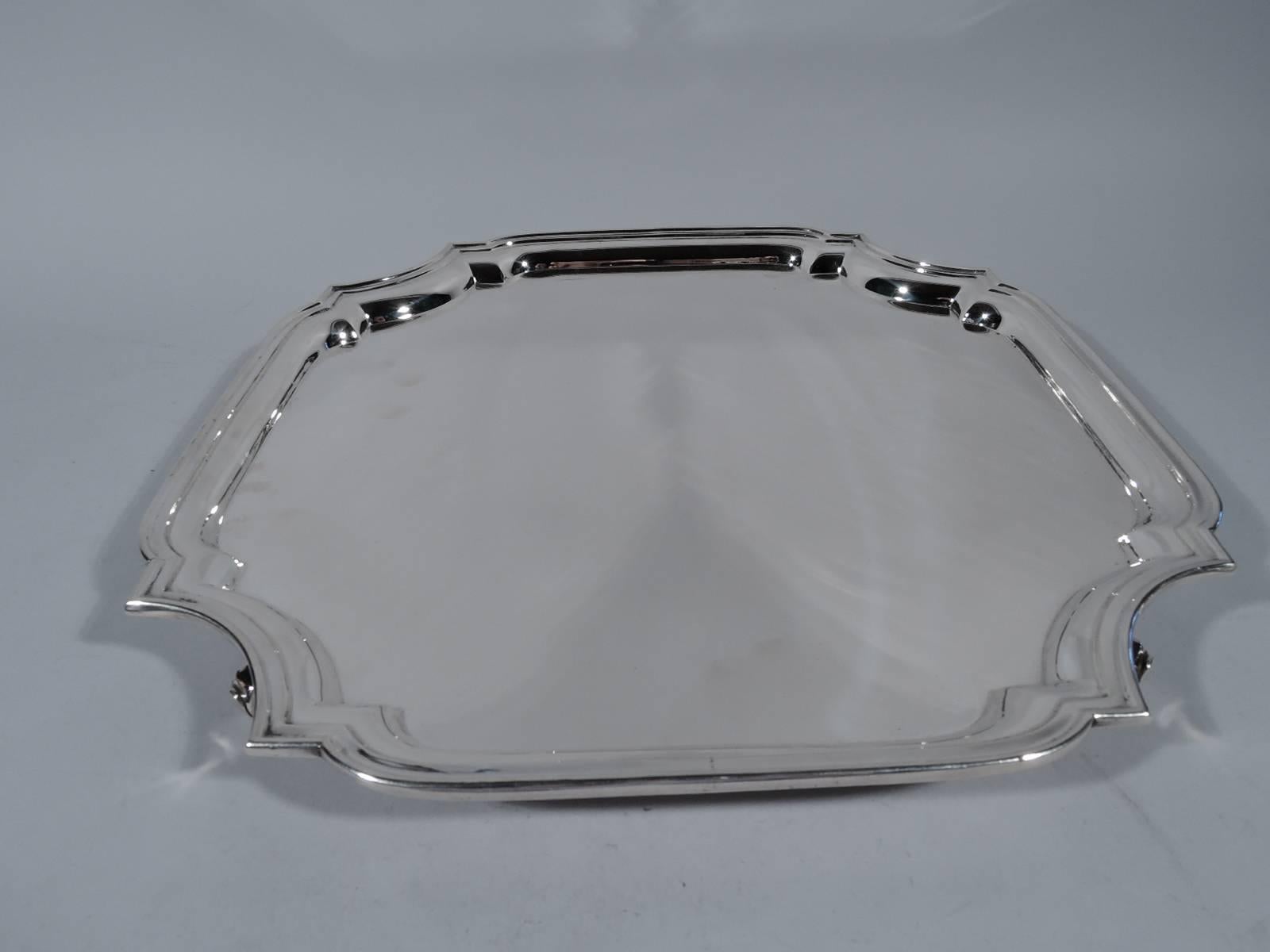 Georgian-style sterling silver salver. Made by Tiffany & Co. in New York. Four sides with concave corners and molded rim. Four volute scroll supports. A fine traditional piece. Hallmark includes postwar pattern no. 25147. Measure: Heavy weight 48