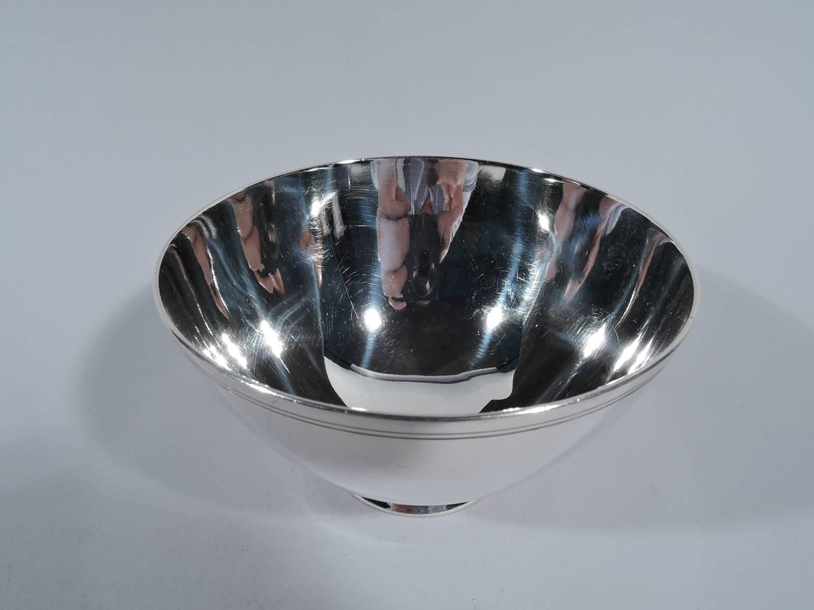Art Deco sterling silver bowl. Made by Tiffany & Co. in New York, circa 1923. Wide mouth with curved and tapering sides and short spread foot. Two incised bands near rim. Hallmark includes pattern no. 20226 (first produced in 1923) and director’s