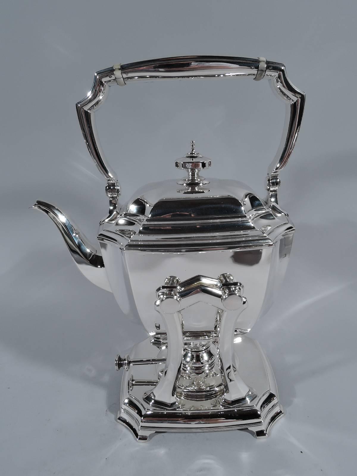 Sterling silver coffee and tea set in desirable Hampton pattern. Made by Tiffany & Co. in New York, circa 1912. This set comprises kettle on stand, coffeepot, teapot, creamer, sugar, and waste bowl. Rectilinear with curved sides, concave