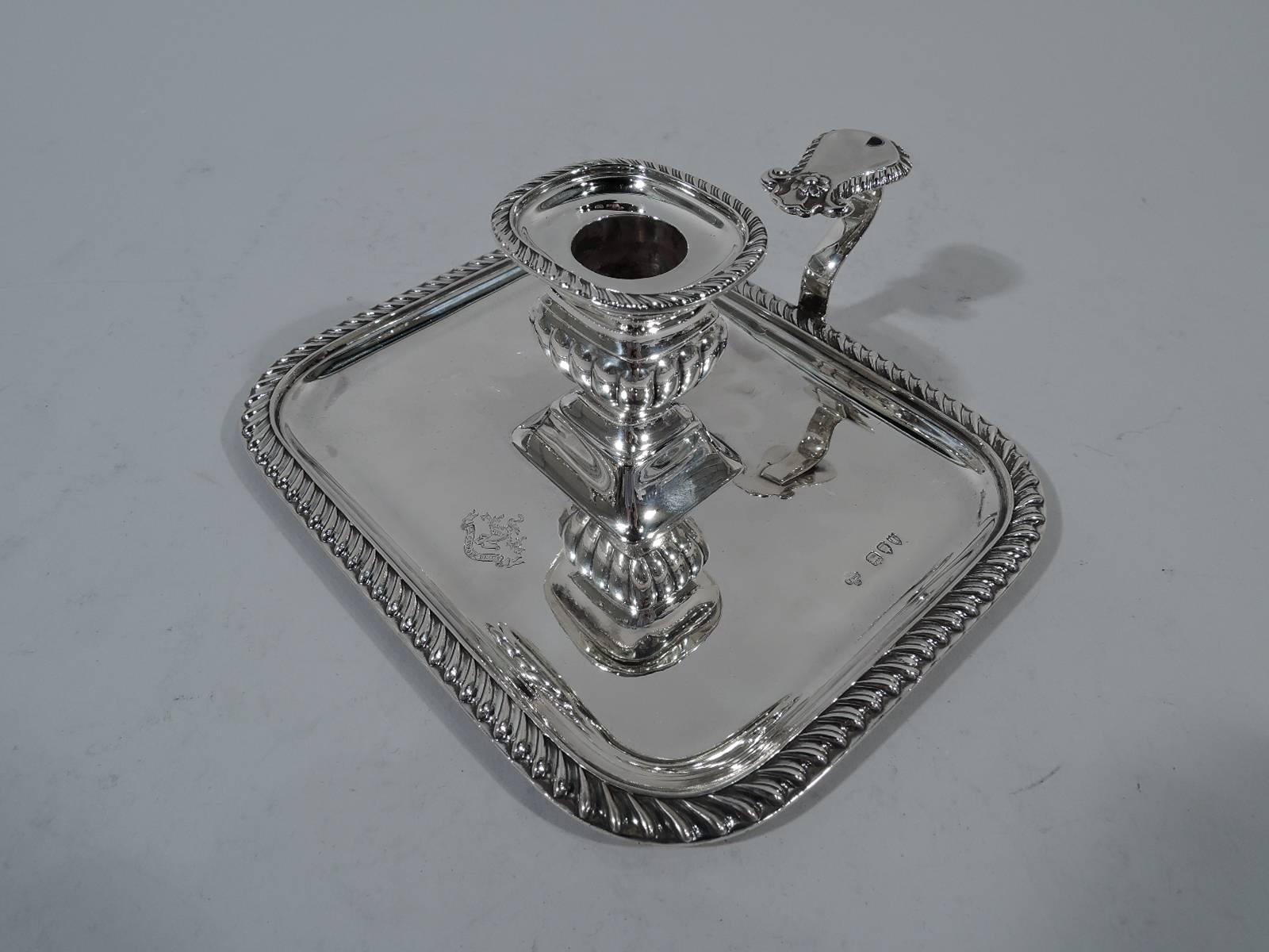 Victorian sterling silver chamberstick. Made by Horace Woodward & Co. in London in 1894. Lobed and bellied socket on raised trapezoidal base mounted to center of rectangular tray. Scrolled handle with impressed thumb rest. Thumb rest, tray, and